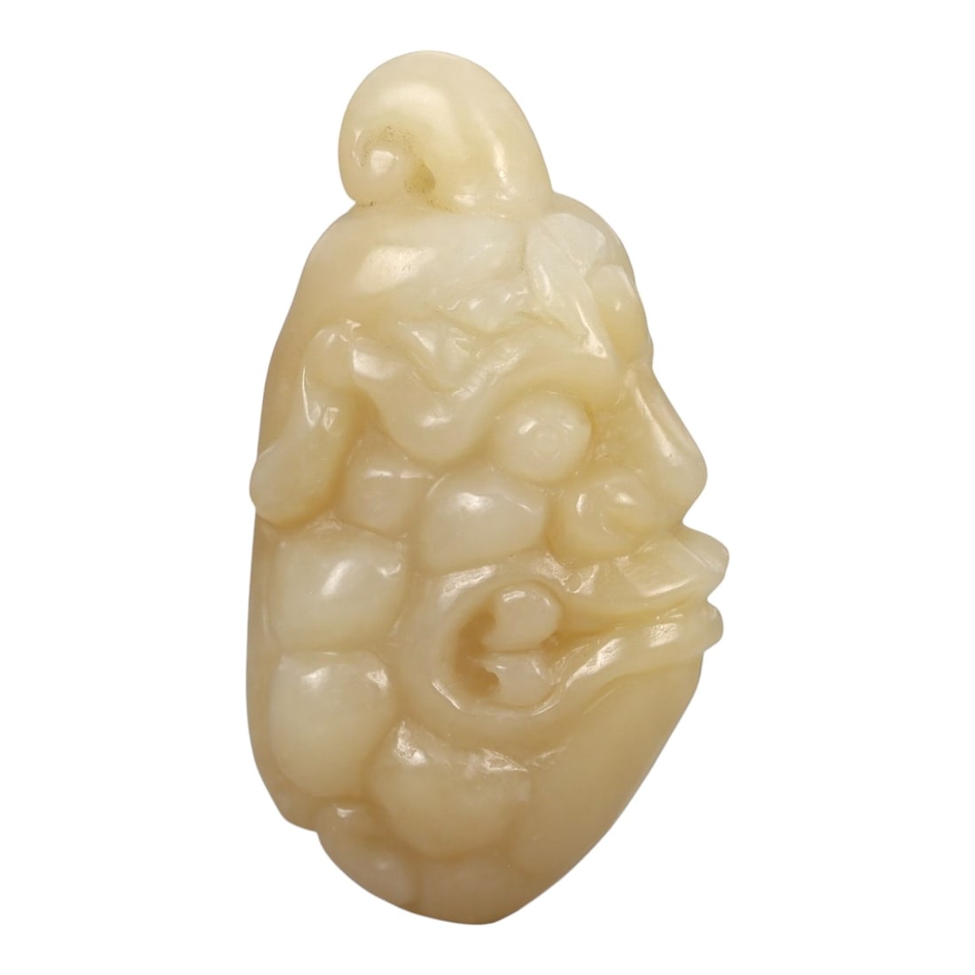 A Chinese Jade Anthropomorphic Head Carving, 20th Century, 34FA: Carved from pale yellow jade with a creamy, semi-translucent appearance and subtle tonal variation, the object represents an anthropomorphic head rendered in relief and partial three-dimensional form.