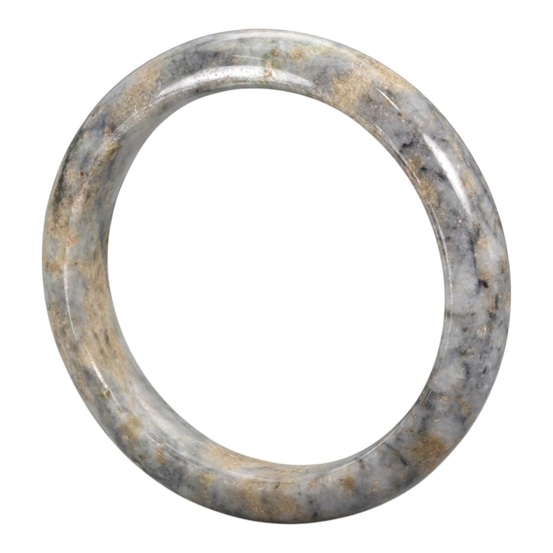 A Chinese Jadeite Jade Bangle Bracelet, 20th Century, 93ZK: Carved from jadeite jade with a pale greyish-white base and irregular tan and dark grey mottling, the bangle is formed as a continuous circular band with a rounded cross-section. The surface is smooth
