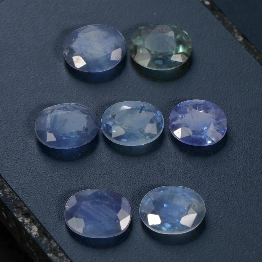 2.52 Carats Natural Multicolor Australian Sapphire Parcel - 7pcs Heated Only, 15YE: This parcel of seven natural sapphires showcases a lovely range of cool, natural hues, from soft cornflower blue and delicate lavender to subtle teal and pale aqua tones. Each oval-cut stone features 