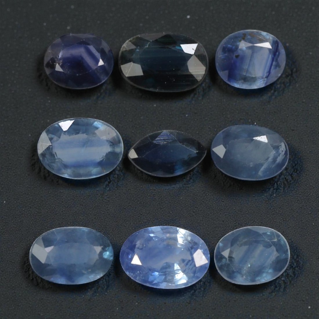 4.23 Carats Natural Multicolor Blue Madagascar Sapphire Parcel - 9pcs Heated Only, 24YE: This parcel of nine natural sapphires showcases a captivating range of cool blue hues, from deep royal blue and rich cornflower to soft sky blue and pale aqua tones. Each stone features faceting desig
