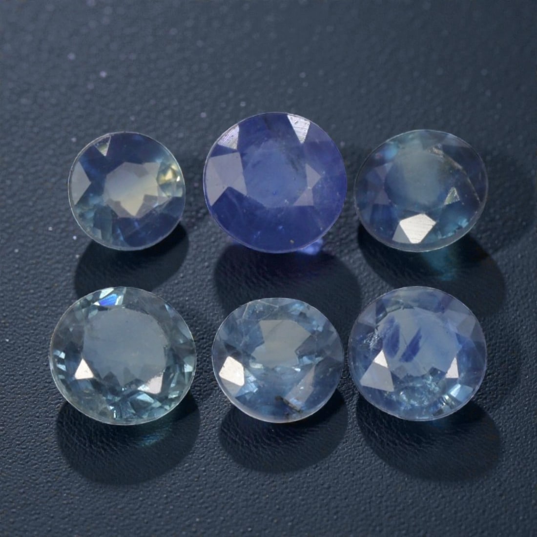 4.23 Carats Natural Multicolor Blue Madagascar Sapphire Parcel - 9pcs Heated Only, 18YE: This parcel of nine natural sapphires showcases a captivating range of cool blue hues, from deep royal blue and rich cornflower to soft sky blue and pale aqua tones. Each stone features faceting desig