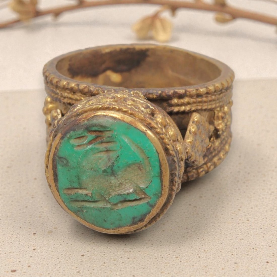 Antique Qajar Dynasty Gilt Intaglio Ring, US Size 8.5, 81WS: This ring features a circular turquoise intaglio carved with a recumbent quadruped, executed in the glyptic style characteristic of Qajar period Iran. The turquoise displays natural color variations a