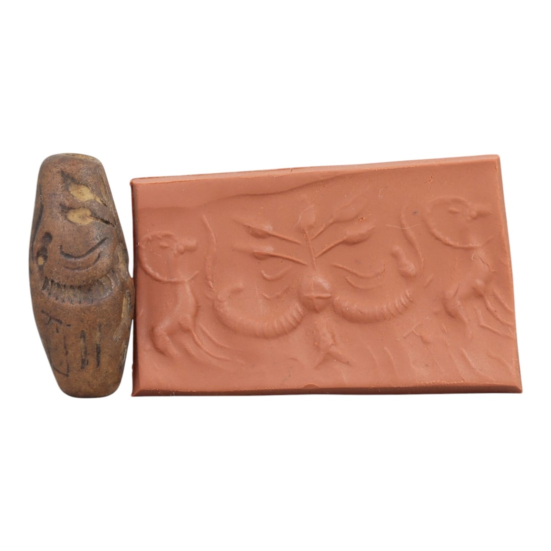 Ancient Steatite Cylinder Seal - Mesopotamian Animal & Botanical Motif Scene, 59AN: Carved from dense steatite, this ancient Mesopotamian cylinder seal features a precise linear relief composition of leaping animal figures flanking a central symmetrical botanical motif, executed in t