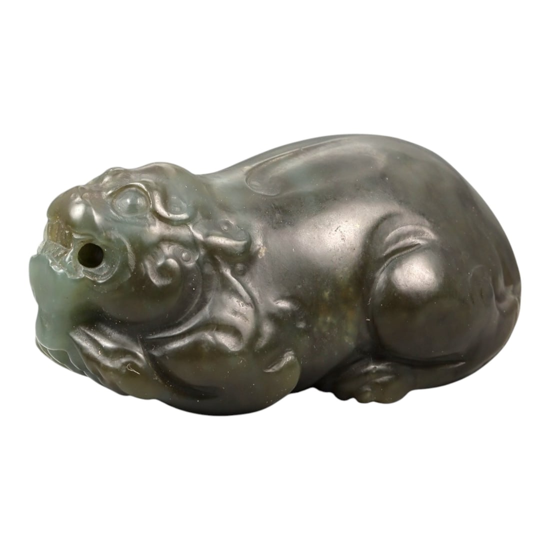 Chinese Jade Pixiu Beast - Carved Animal Figurine 5.5cm, 100ZC: Carved from green jade with areas of soft translucency and darker natural inclusions, this sculptural figure depicts a pixiu shown in a compact recumbent posture. The carving is executed fully in the 