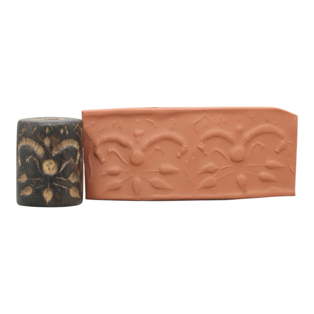 Ancient Steatite Cylinder Seal - Mesopotamian Symmetrical Botanical Motif, 97ZR: Carved from dense steatite, this ancient Mesopotamian cylinder seal features a precise symmetrical relief composition of repeated botanical and curvilinear motifs, executed in the characteristic glypt