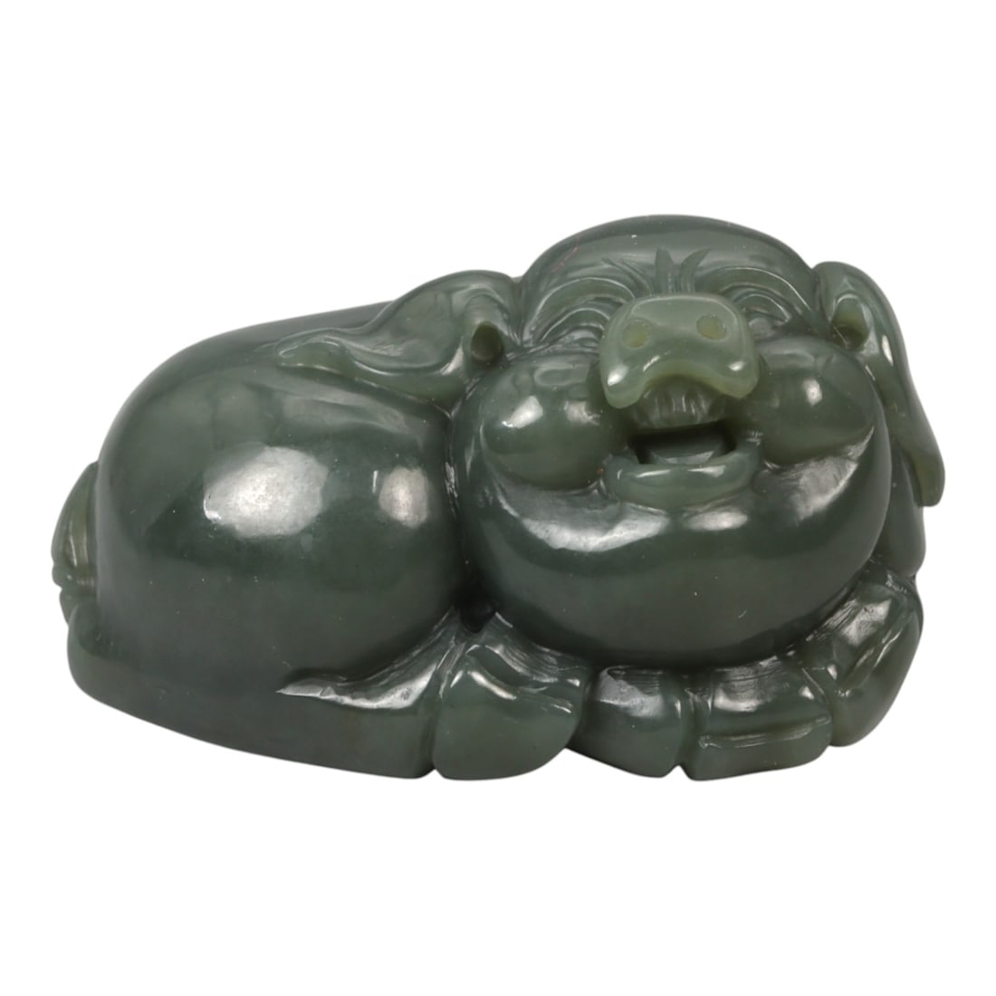A Chinese Nephrite Jade Pig Figure, 20th Century, 92YA: Carved from dark green nephrite jade with subtle tonal variation and a high-polished surface, the figure represents a recumbent pig shown in a compact, rounded posture. The head is rendered with a bro