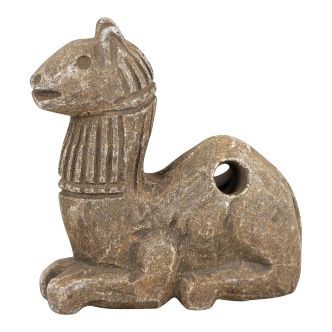 Ancient Stone Camel Amulet - Near Eastern Desert Talisman, 26AM: This amulet is carved from warm beige stone with natural speckling and a weathered patina, depicting a stylized camel in a recumbent, crouched posture. The piece features incised linear detailing defi