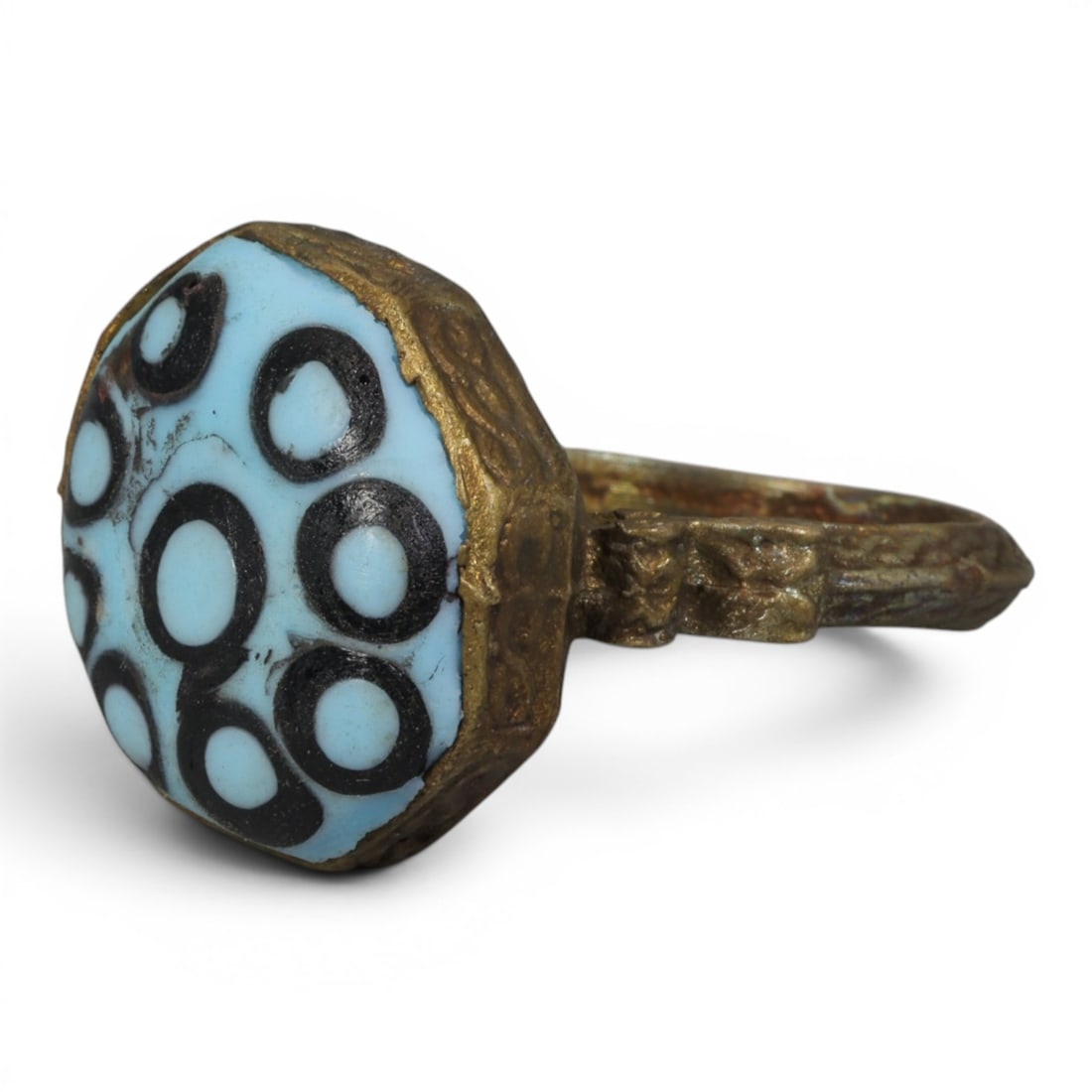 Antique Qajar Dynasty Gilt Evil Eye Ring, US Size 9.5, 18AJ: A gilt-metal ring of the Qajar period, US ring size 9.5, featuring a large domed evil-eye glass inlay with a vibrant light blue base adorned with multiple black-and-white concentric eye motifs. The oc