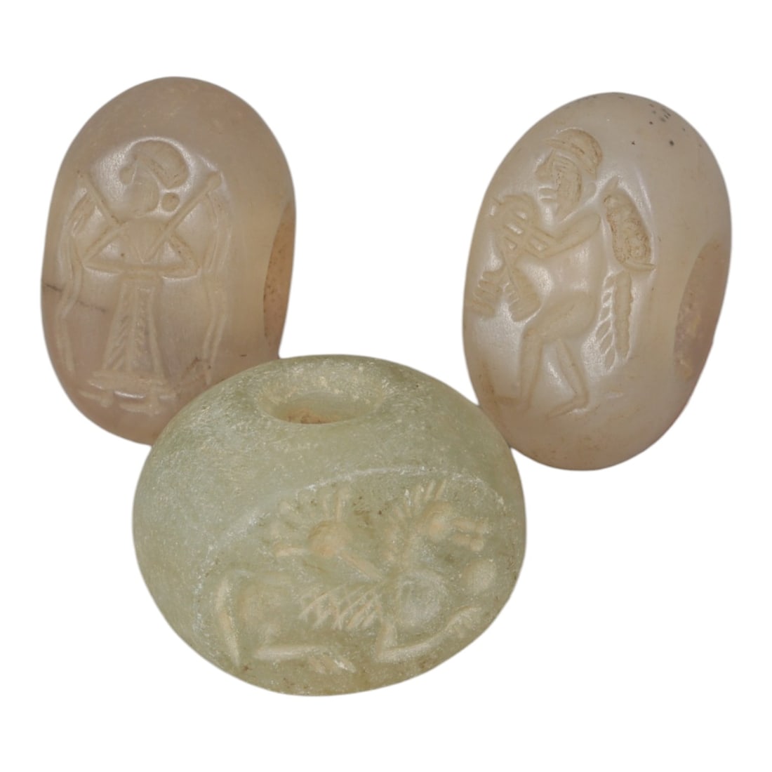 Lot of 3 Sasanian Stone Stamp Seals, Circa 3rd-7th Century CE, 8AG: Comprising three seals carved from stone, including pale translucent and light greenish examples, with natural surface patina and minor wear consistent with age. Each seal is oval to disc-shaped with 