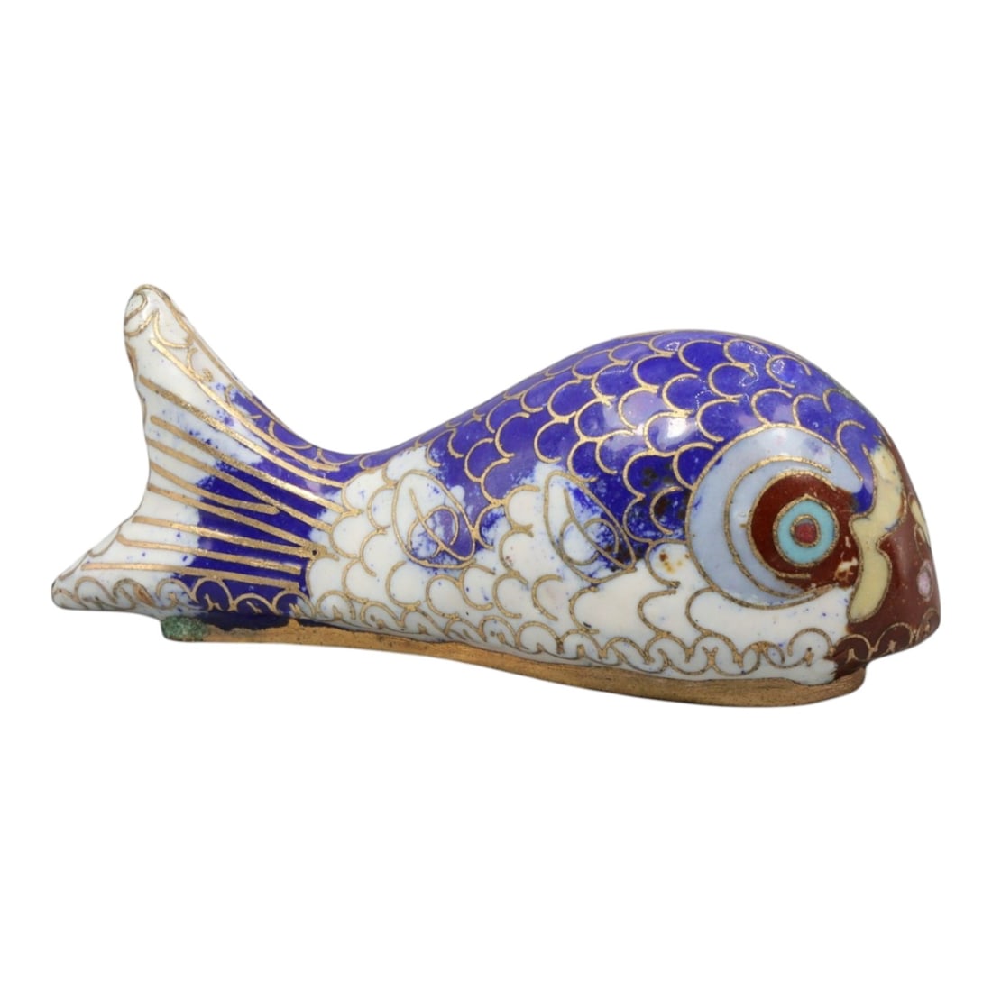 A Chinese Cloisonne Enamel Fish Effigy, 20th Century, 74YC: Constructed from a copper alloy body and decorated with cloisonne enamel, the object is formed as a stylized fish shown in profile with an elongated body and gently tapering tail. Fine metal wire cloi