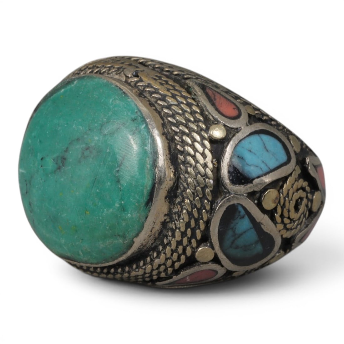 Antique Central Asian Silver and Turquoise Tribal Ring, 19th-Early 20th Century, 71AJ: The ring is set with a large, smooth cabochon turquoise stone, displaying natural matrix inclusions within its green-blue matrix. The silver mount is decorated with pseudo-filigree scale-pattern wirew
