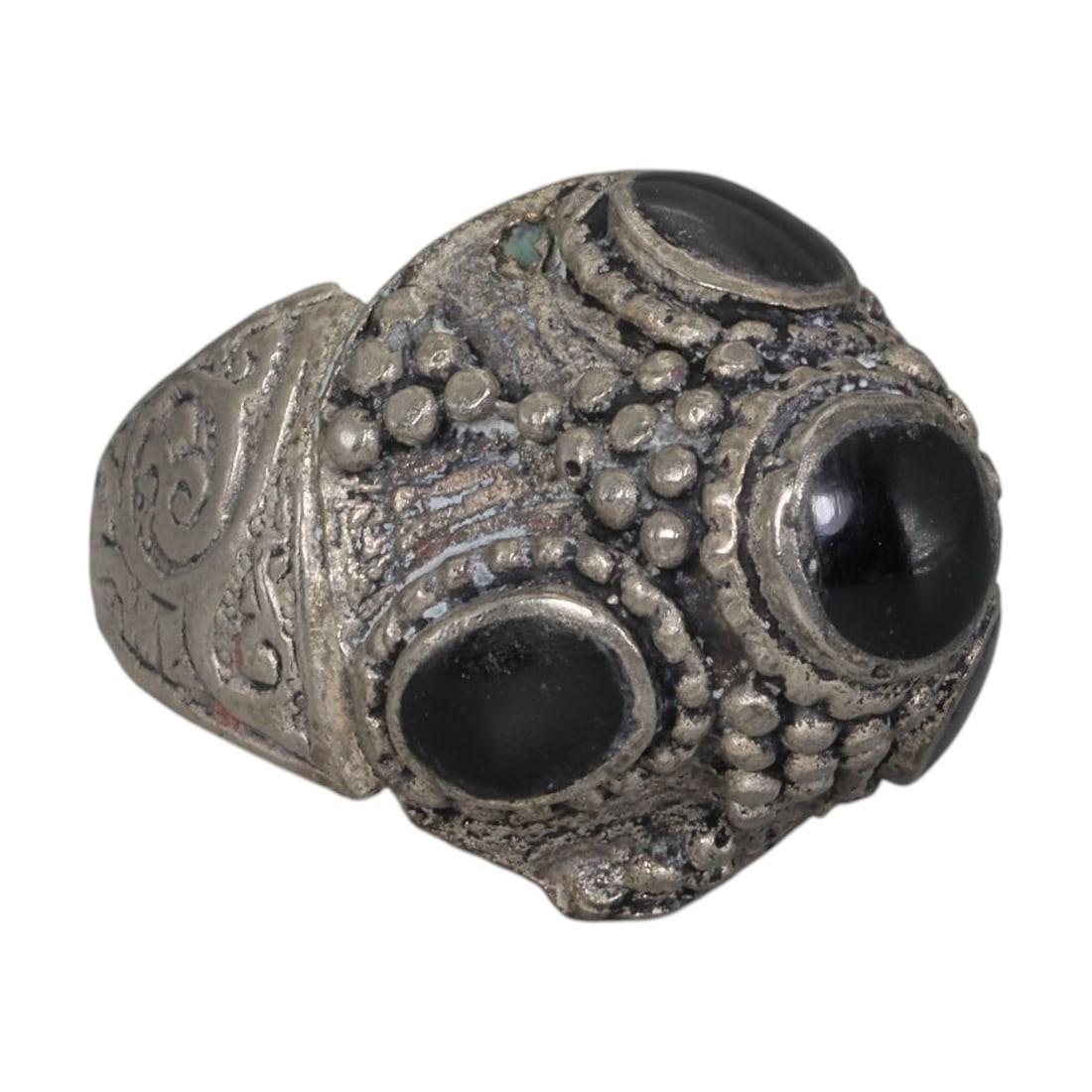 A Middle Eastern Silver Plated Multi-Stone Onyx Ring, Late 19th-Early 20th Century, 31AK: The ring features multiple round and oval cabochon onyx stones set within an ornate domed bezel decorated with raised granulation. The bezel and shoulders are engraved with intricate scrolling foliate