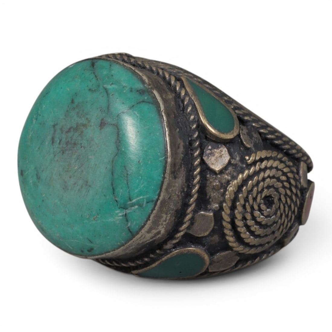 Antique Central Asian Silver and Turquoise Tribal Ring, 19th-Early 20th Century, 63AJ: The ring is set with a large, smooth cabochon turquoise stone, displaying natural matrix inclusions and surface cracks within its green-blue matrix. The silver mount is decorated with pseudo-filigree 