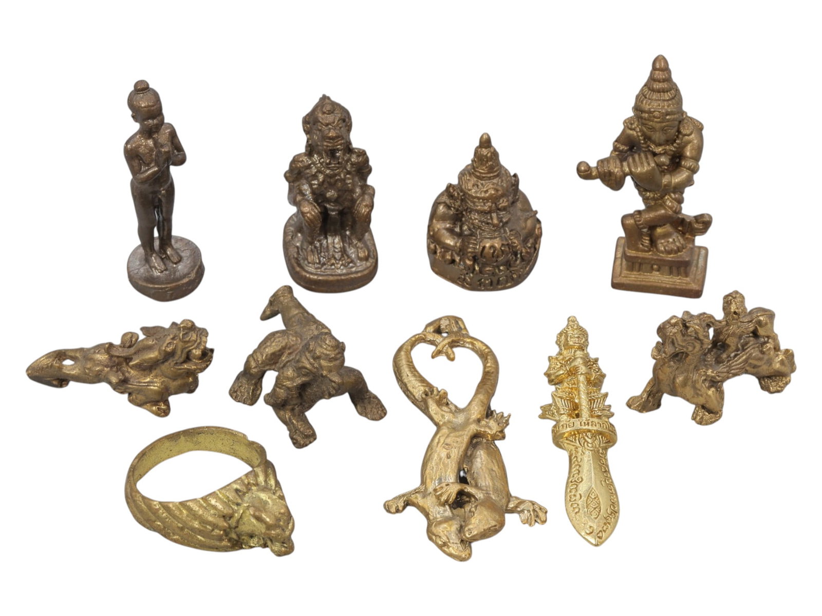 A Lot of 10 Vintage Southeast Asian Brass and Bronze Amulets and Figurines, 3WT: A curated lot of ten vintage Southeast Asian amulets and figurines, crafted from brass and bronze with varied patinas and finishes. The collection includes devotional deity figures, guardian and mythi
