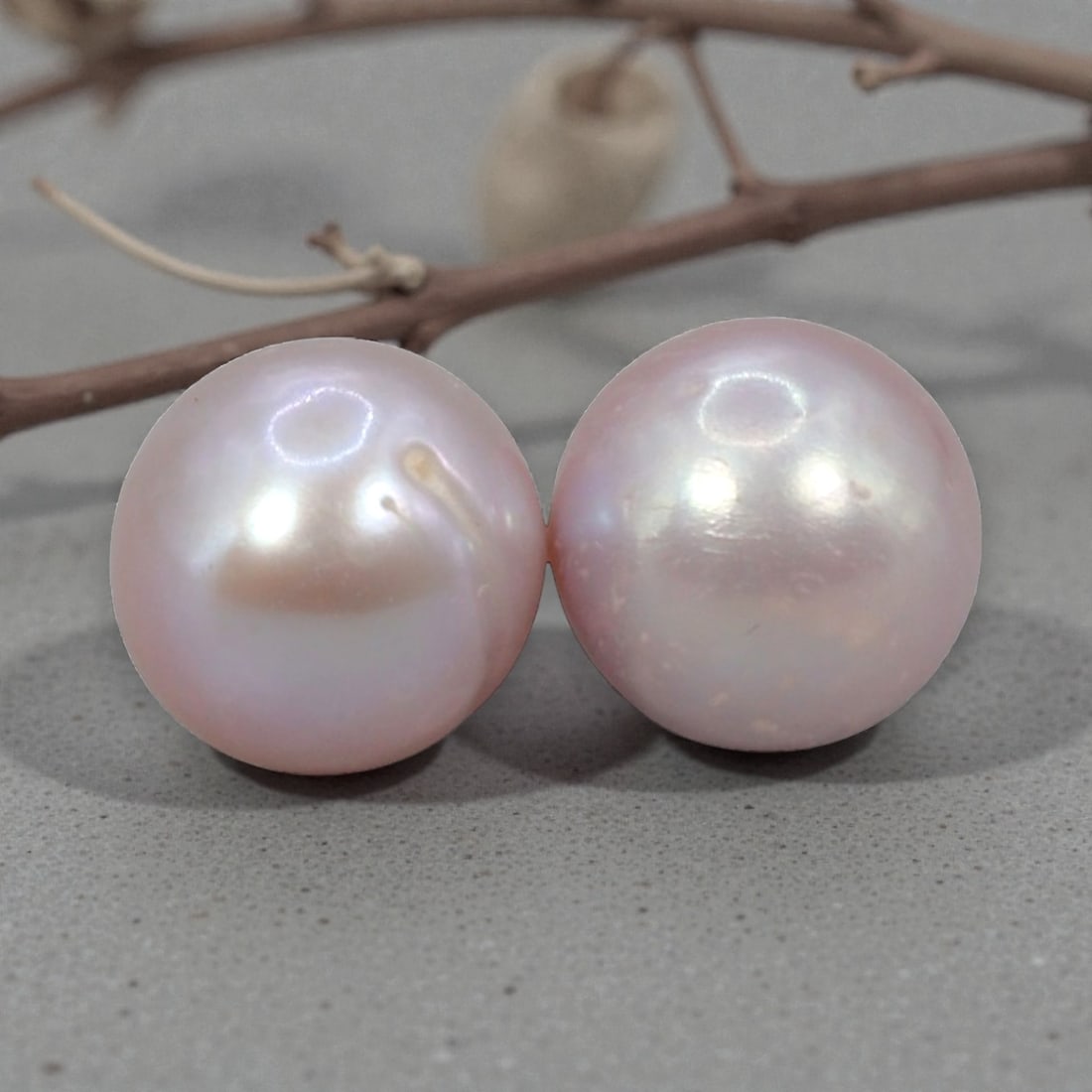 Freshwater Pearl Pair - Natural Pearl Lavender Round Gemstones 7.5mm, 27XA: A matched pair of natural freshwater pearls, exhibiting a soft lavender-pink hue with moderate luster and subtle iridescent orient. The pearls are near-spherical, with visible natural surface inclusio