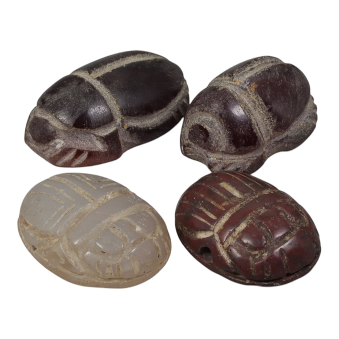 Lot of 4 Ancient Coptic Egyptian Carnelian & Stone Scarabs, Circa Roman to Coptic Era, 97WT: Carved from carnelian and light-toned stone, the group consists of four distinct scarab amulets. Each piece features the characteristic scarab form with incised details representing the beetle's back,