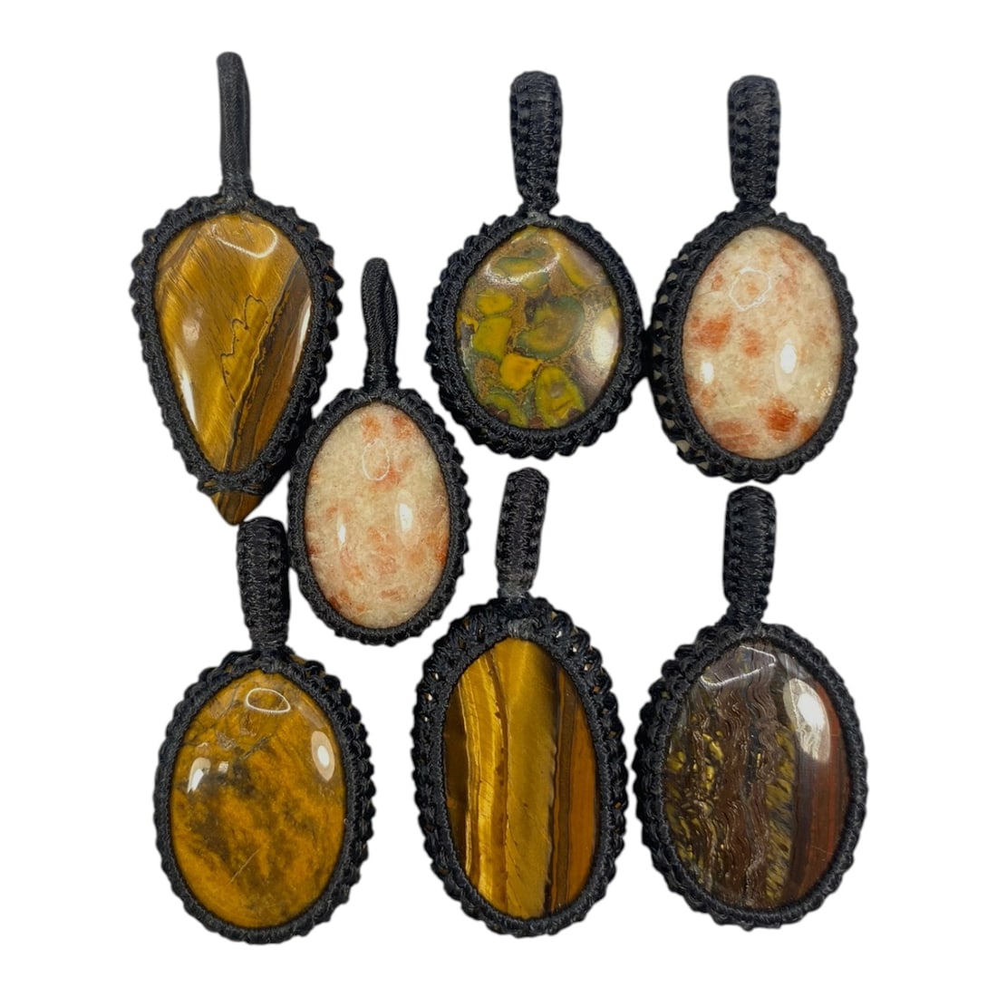 A Lot of 7 Macrame-Wrapped Gemstone Pendants, 9WS: This lot includes seven handcrafted macrame-wrapped gemstone pendants, each measuring 4-5 cm in height. The collection features varied natural stones, including tiger's eye, sunstone, and a patterned 