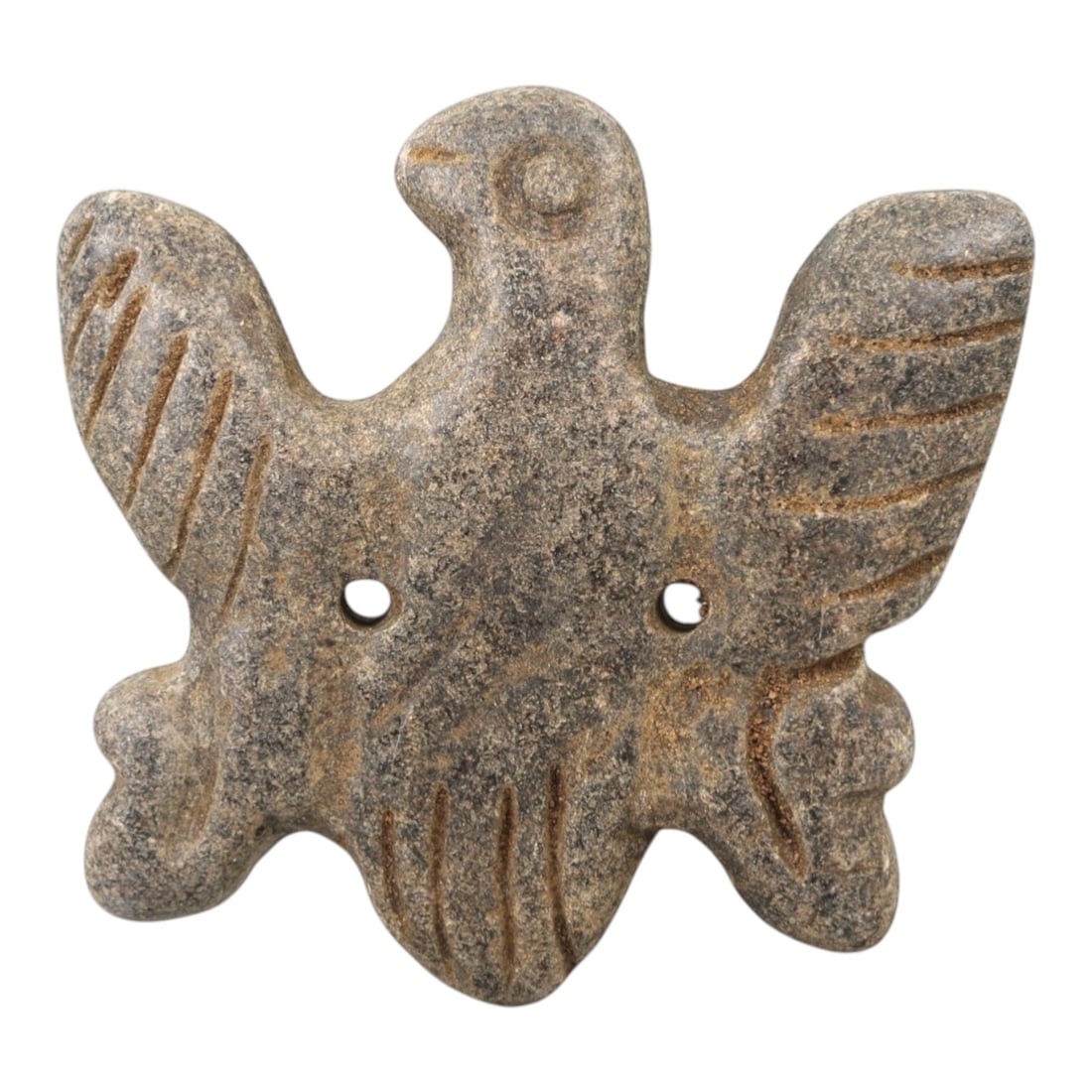 Ancient Stone Vulture Amulet - Near Eastern Bird Figure, 51AM: This amulet is carved from dark speckled stone, depicting a stylized vulture with outstretched wings and a compact body, rendered in raised relief with incised linear detailing defining the wing feath