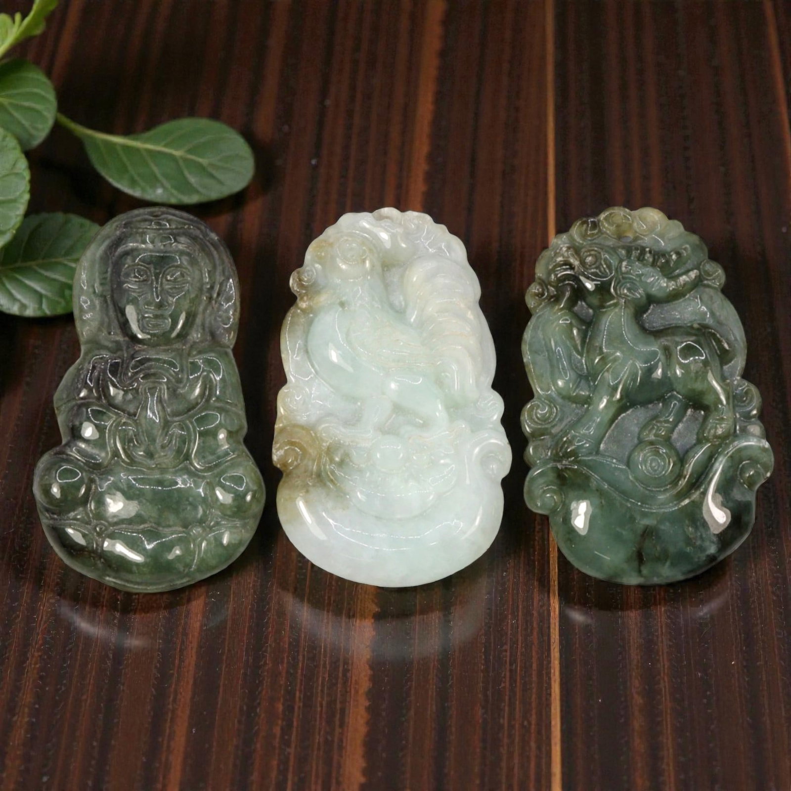 Lot of 3 Antique Oriental Chinese Jadeite Jade Pendants, 71WM: A curated lot of three Chinese jadeite pendants, each carved from natural jadeite stone with varying green tones and natural inclusions. The collection includes a seated Guanyin figure, a rooster zodi