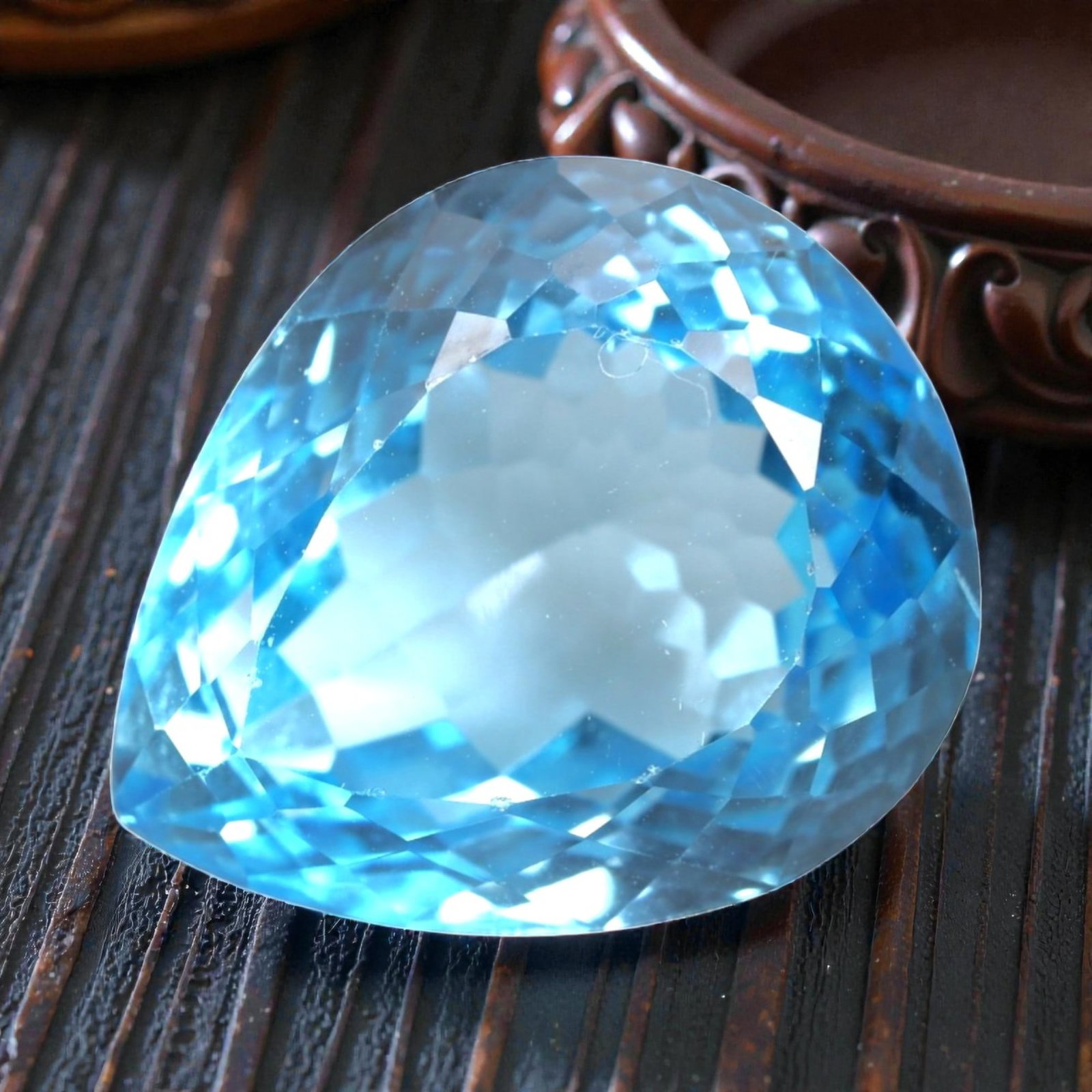33.87 Carats Swiss Blue Topaz Pear - Natural Brazilian Stone, LZ105: This striking pear-cut Swiss blue topaz captivates with a vivid, saturated blue hue that evokes the crisp clarity of a summer sky. Its expertly faceted cut features precisely angled surfaces that maxi