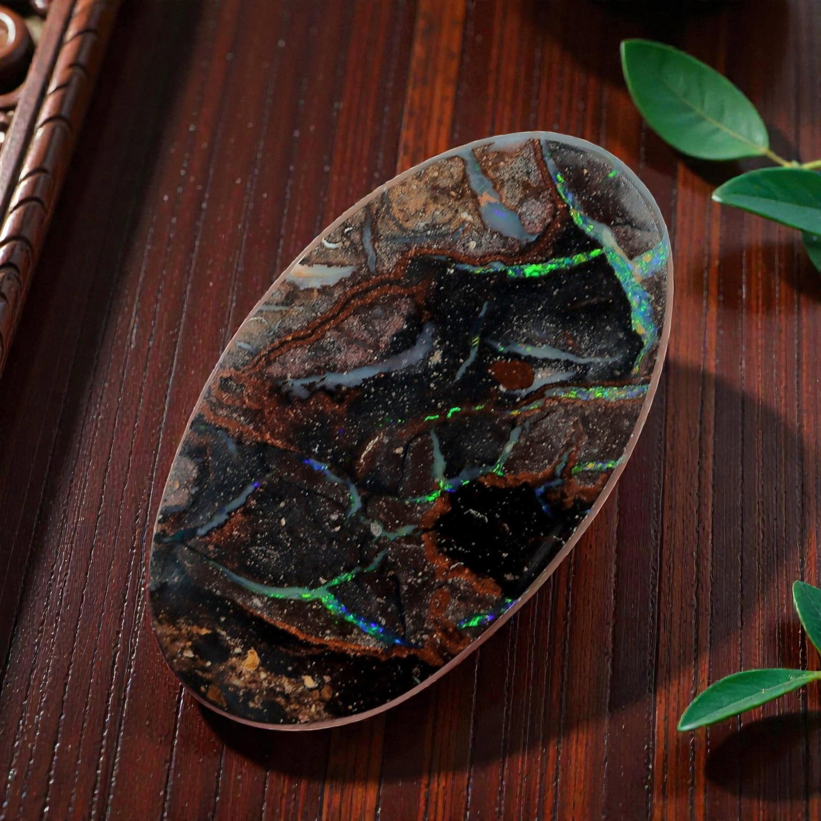 2.55 Carats Koroit Boulder Opal Cabochon - Natural Australian Stones 11.8x6.8mm, 9XM: This striking 2.55-carat Koroit boulder opal cabochon is a natural geological masterpiece, featuring vivid veins of iridescent play-of-color that snake through a rich, dark ironstone matrix. The elong