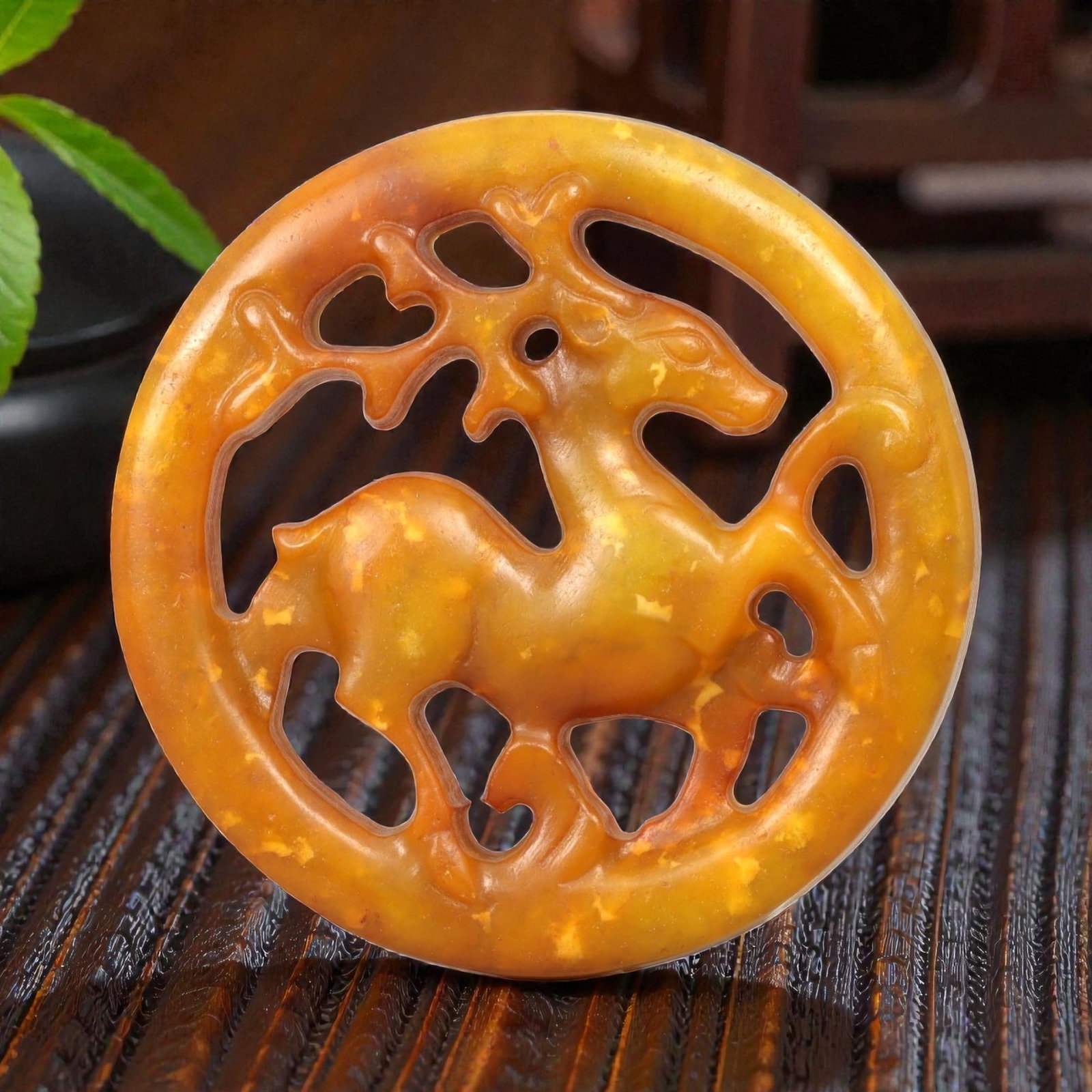 A Chinese Hetian Jade Openwork Deer Plaque, 20th Century, 52FH: Carved from warm honey-yellow Hetian jade with mottled tonal variation and natural inclusions, the plaque is circular in form and executed in openwork. The central motif depicts a standing deer shown 