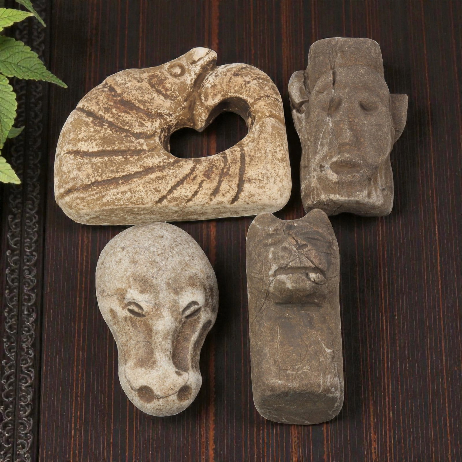 Lot of 4 Medieval Tribal Stone Carvings, 22WT: A set of four hand-carved stone objects, measuring approximately 4-6 cm in height, showcasing medieval tribal stonework. The pieces include a stylized animal-form carving with a heart-shaped opening, 