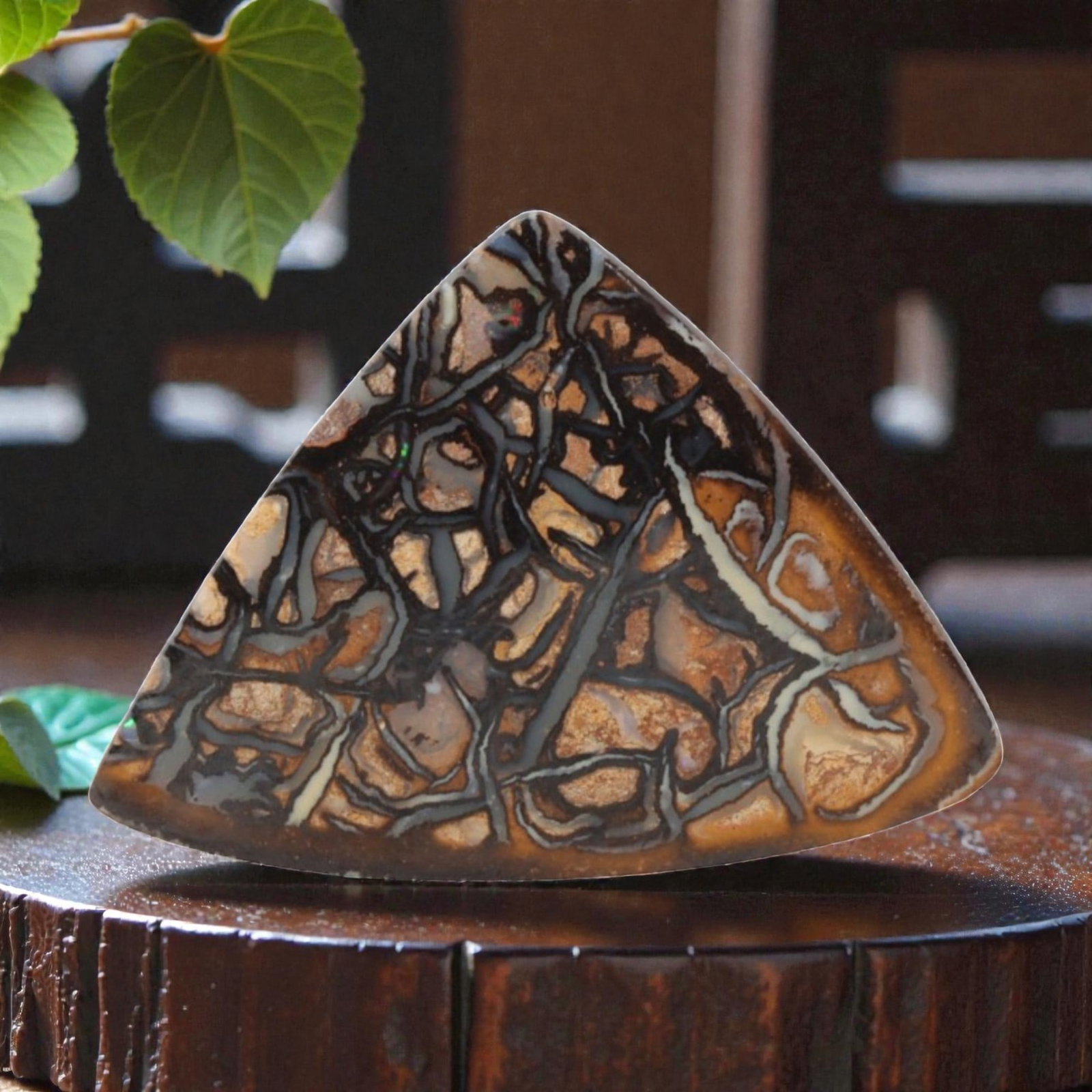 16.80 Carats Matrix Boulder Opal Triangular Cabochon - Natural Australian Stone, 16XC: This striking matrix boulder opal cabochon, measuring 23.9 x 17.6 x 5.6 mm, is a dramatic display of natural geological artistry. Polished into a bold triangular shape, the stone features an intricate
