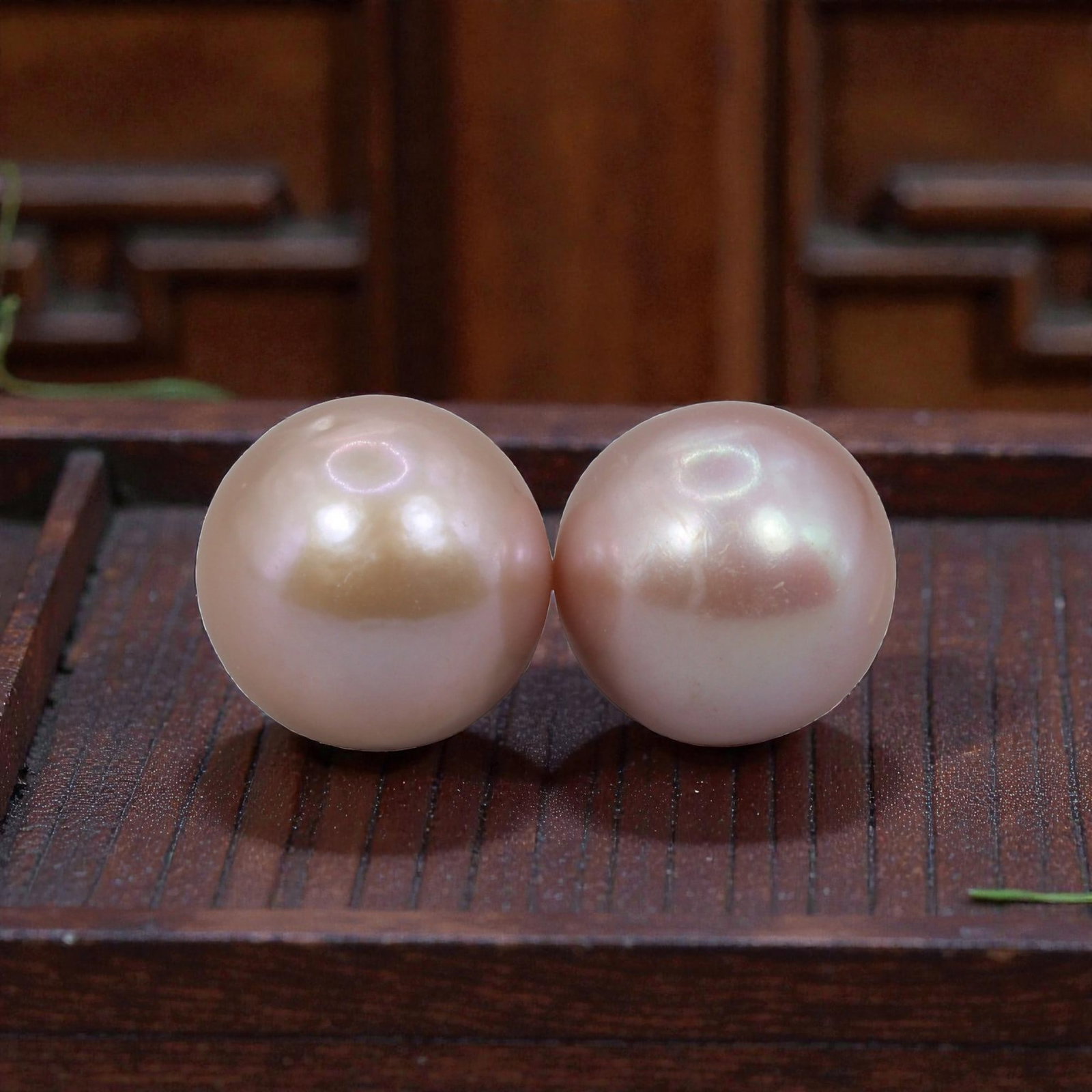 Freshwater Pearl Pair - Natural Pearl Pink Round Gemstones 11mm, 30XA: A matched pair of natural freshwater pearls, exhibiting a soft pinkish-peach body tone with fine, iridescent luster and subtle orient. The pearls are near-spherical, with smooth nacre and minor natura