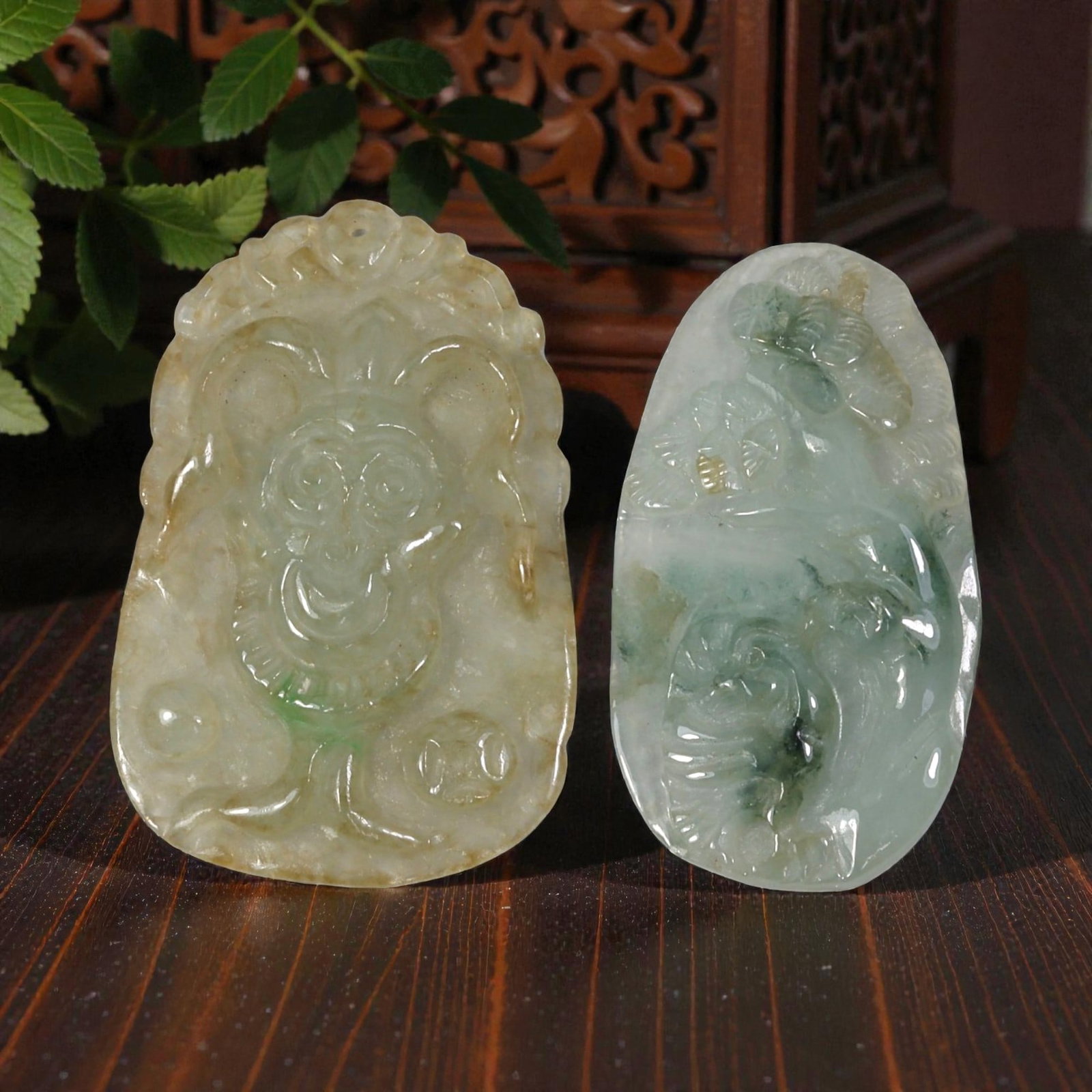 Lot of 2 Antique Oriental Chinese Jadeite Jade Pendants, 20AG: The left pendant is carved from translucent light green and yellowish-brown jadeite with subtle green inclusions, featuring a stylized monkey motif holding a coin, flanked by additional coin elements 