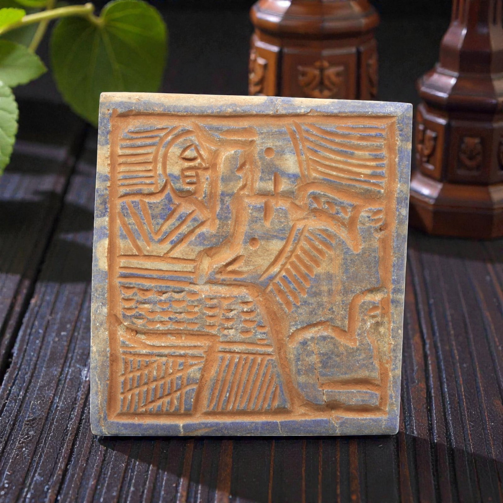 Near Eastern Lapis Lazuli Plaque - Tribal Art Figure & Mythical Creature Relief, 1ZA: Carved from lapis lazuli, this square plaque features a **5.5x5.1cm (2.17x2.01in)** relief composition depicting a stylized human figure in profile alongside a mythical winged creature, executed in th