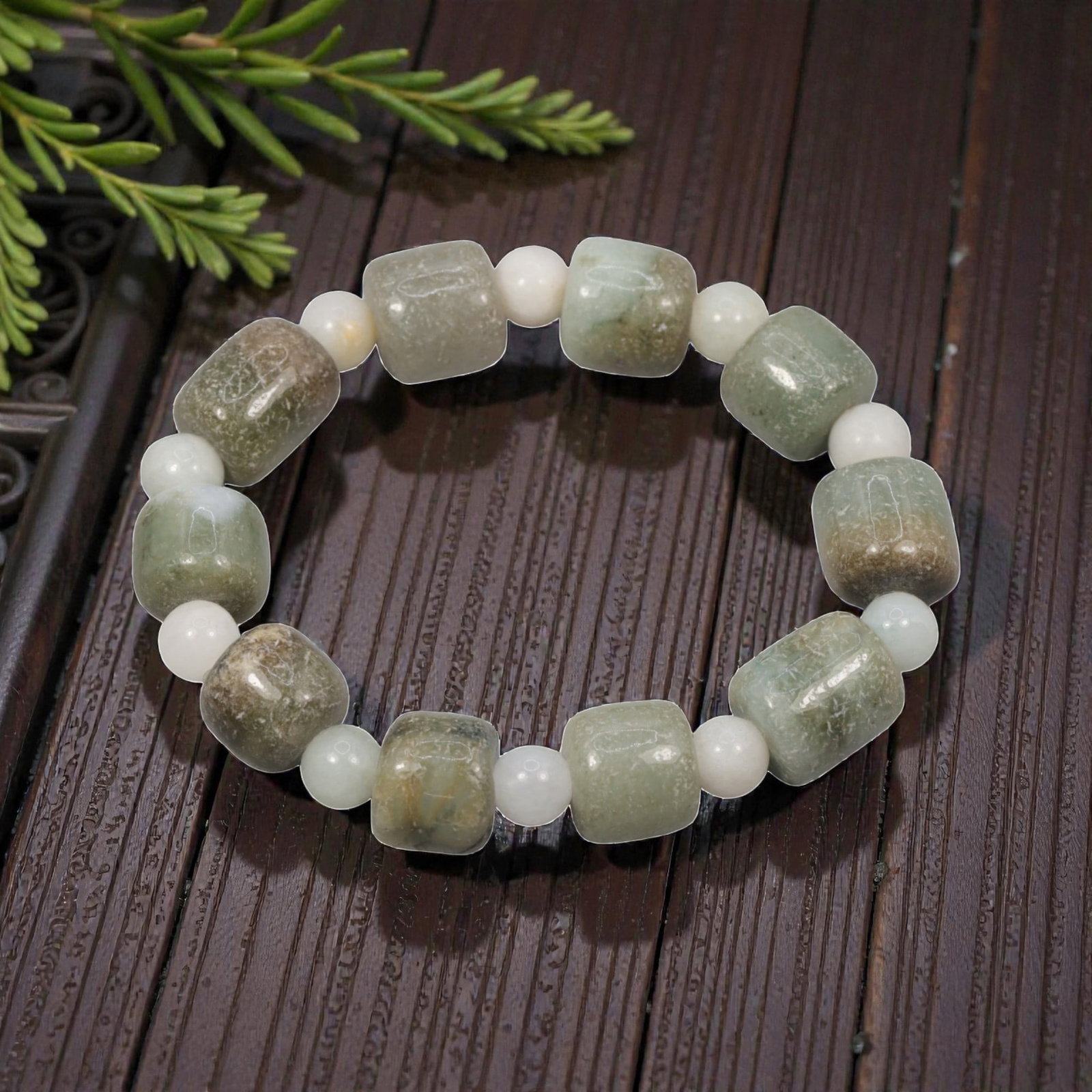 A Chinese Jadeite Jade Bead Bracelet, 20th Century, 42ZK: Composed of a single strand of cuboid and spherical jadeite jade beads forming a circular bracelet. The cuboid beads display natural tonal variation from pale green to deep green, with visible interna
