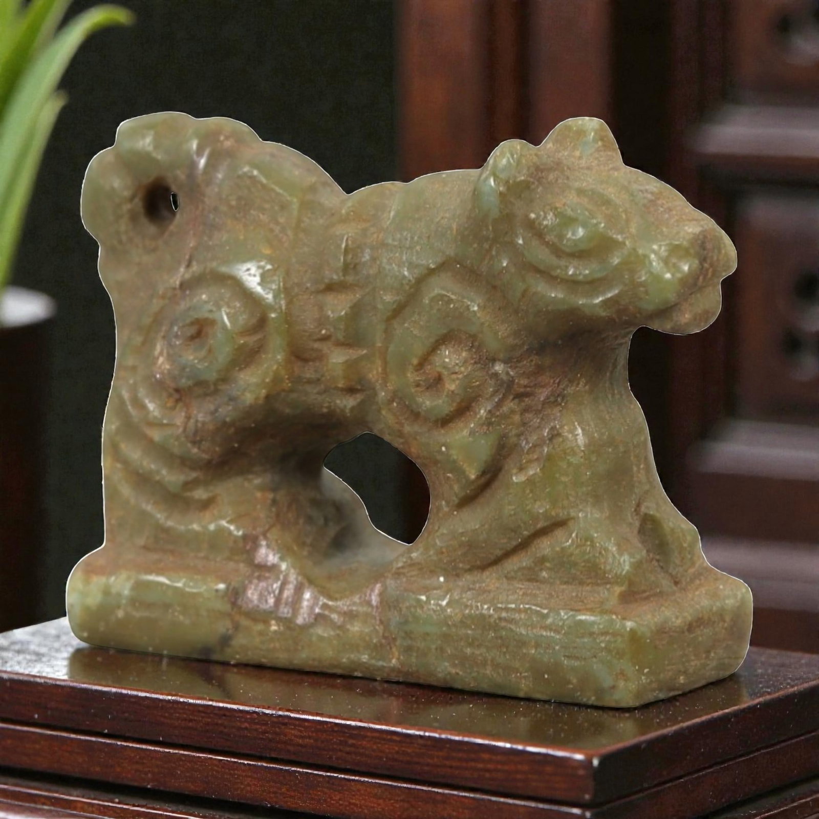 Ancient Serpentine Amulet - Near Eastern Animal Figure, 61AL: This artifact is carved from serpentine, depicting a stylized animal form, likely a feline or feline-like creature, standing on a rectangular integral base. The carving features incised decorative mot