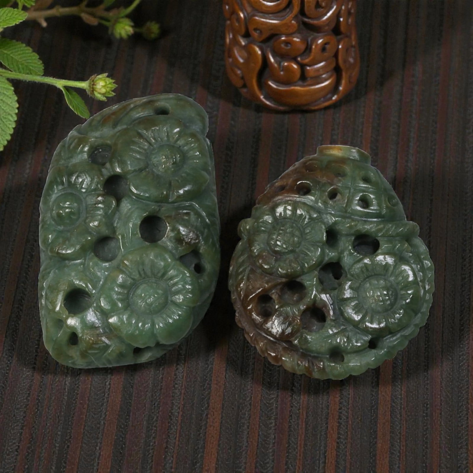 Lot of 2 Antique Oriental Chinese Jadeite Jade Reticulated Floral Carvings, 32AG: The lot comprises two openwork jadeite carvings, both crafted from mottled deep green jadeite with natural russet inclusions. The left piece is elongated and features raised floral motifs with multipl