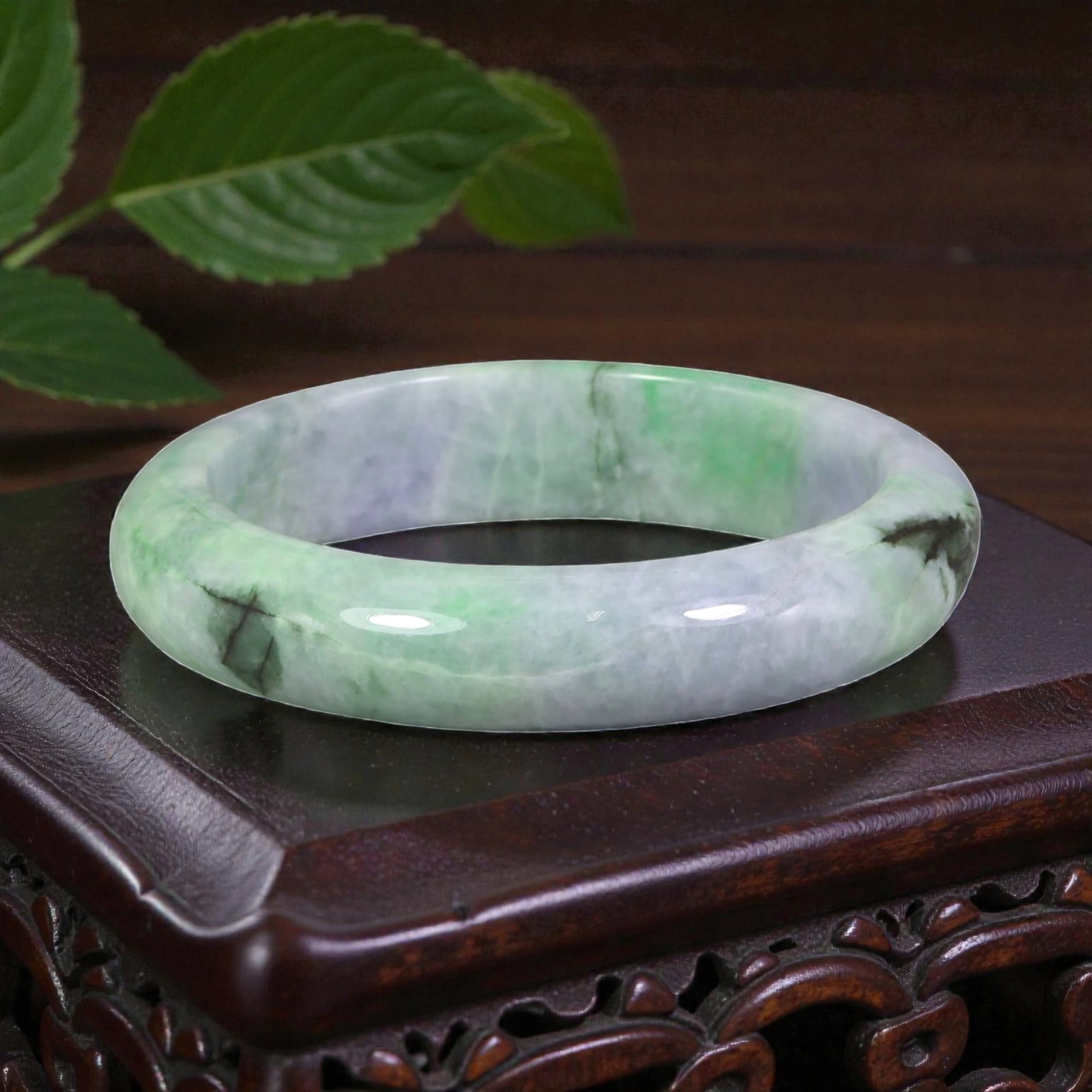 Natural Burmese Type A Lavender & Green Jadeite Bangle - Verdant Swirl Bracelet, 92XE: This is a wide, solid bangle crafted from natural Burmese Type A jadeite, displaying a soft lavender base with vivid verdant green swirls and subtle dark accents throughout the polished stone. The sur