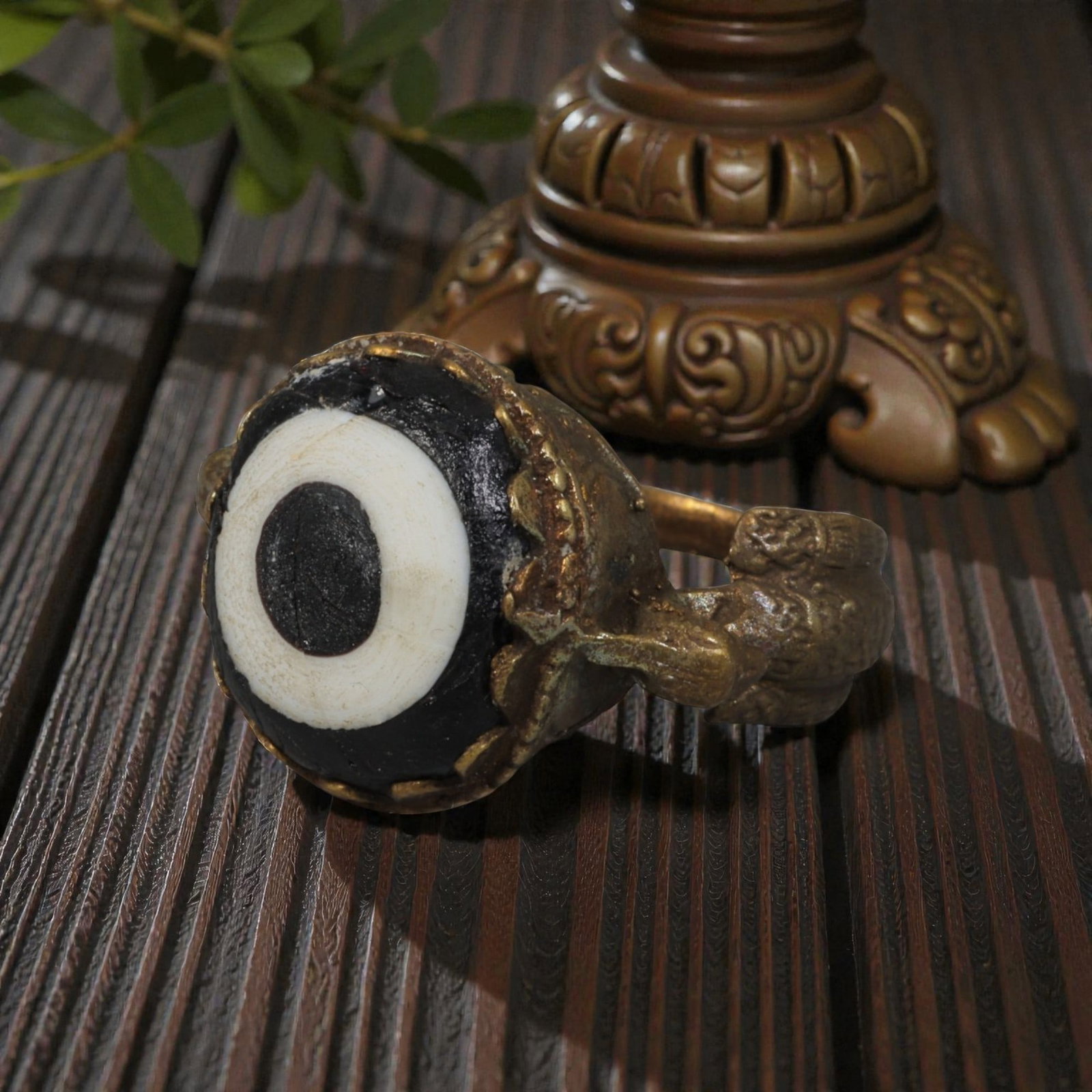 Antique Qajar Dynasty Gilt Evil Eye Ring, US Size 8, 32AJ: A gilt-metal ring of the Qajar period, US ring size 8, featuring a large domed evil-eye glass inlay with a bold concentric black-and-white design (the glass exhibits age-related cracks and patina). Th
