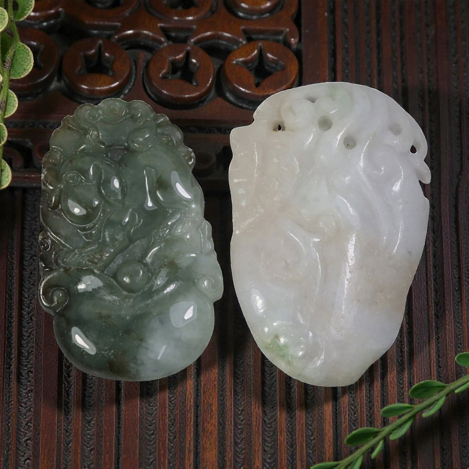 Lot of 2 Antique Oriental Chinese Jadeite Jade Carved Pendants, 50AG: Carved from jadeite jade with natural color variations, the two pendants feature traditional relief motifs. The left pendant, in varying shades of green with darker inclusions, depicts a stylized myth