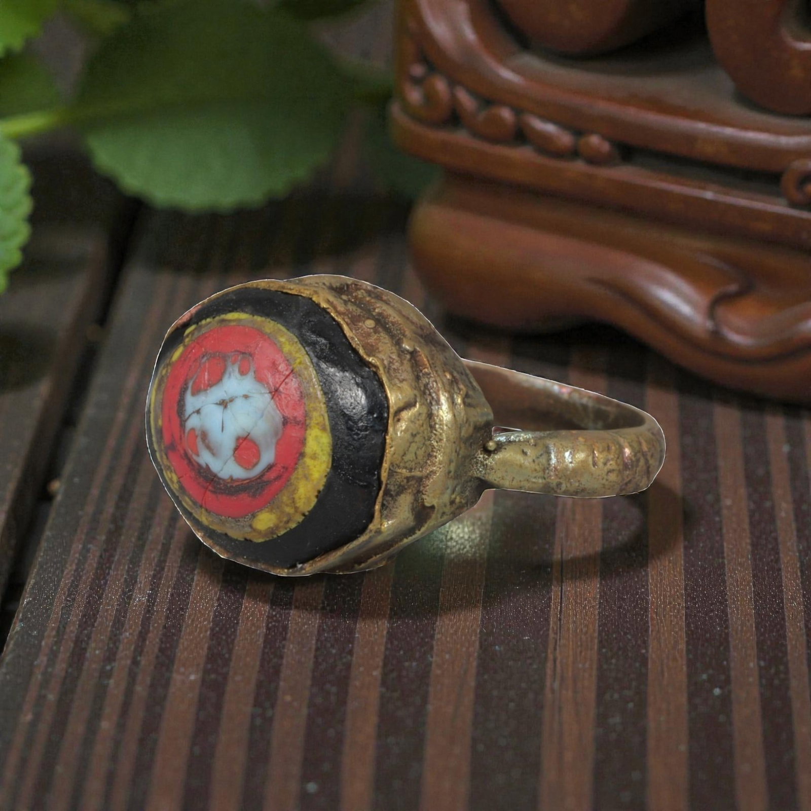 Antique Qajar Dynasty Gilt Evil Eye Ring, US Size 9.5, 11AJ: A gilt-metal ring of the Qajar period, US ring size 9.5, featuring a large, domed evil-eye glass inlay with vibrant concentric red, yellow, black, and white layers. The central motif is a stylized evi