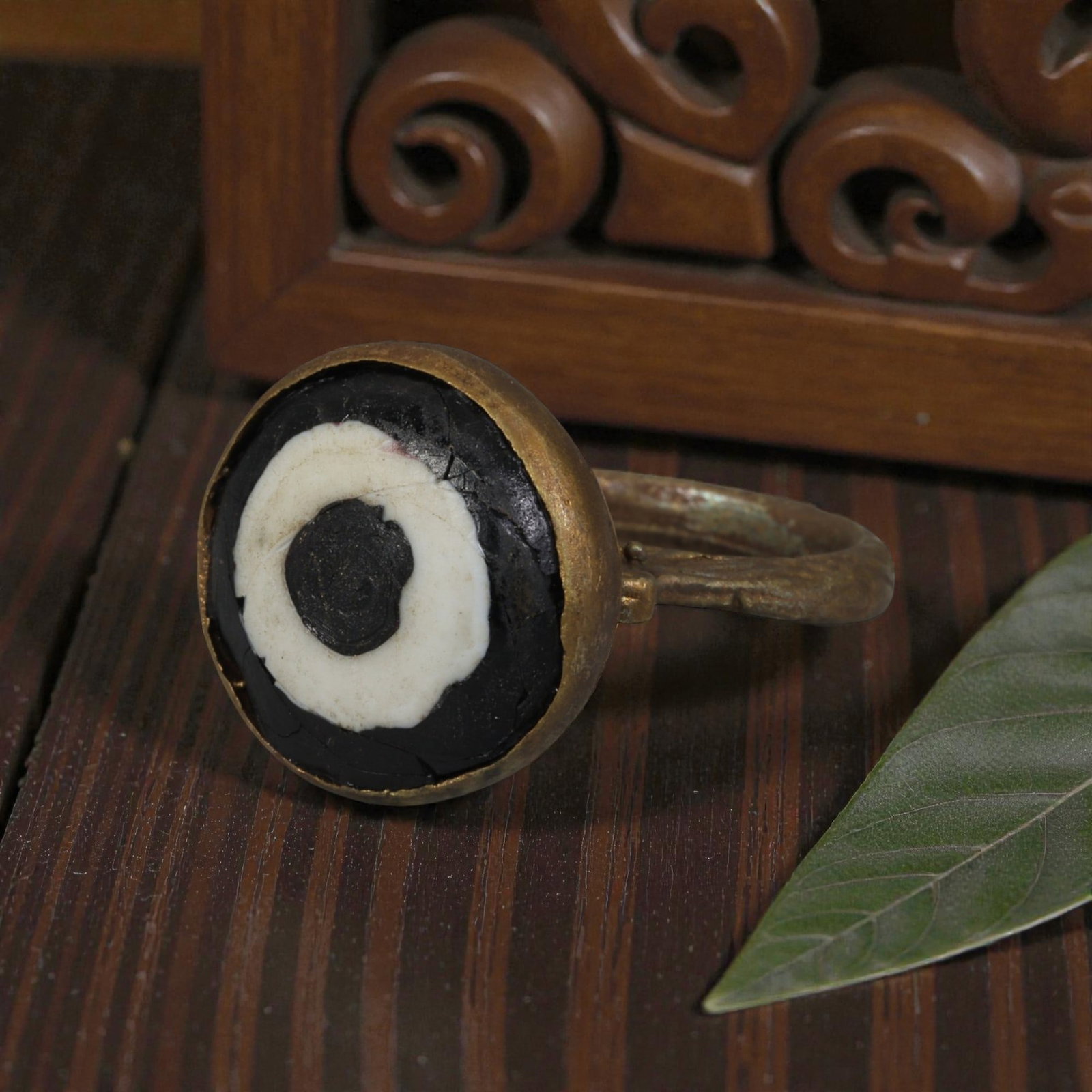 Antique Qajar Dynasty Gilt Evil Eye Ring, US Size 8, 37AJ: A gilt-metal ring of the Qajar period, US ring size 8, featuring a large domed evil-eye glass inlay with a bold concentric black-and-white design (the glass exhibits age-related cracks). The domed bez