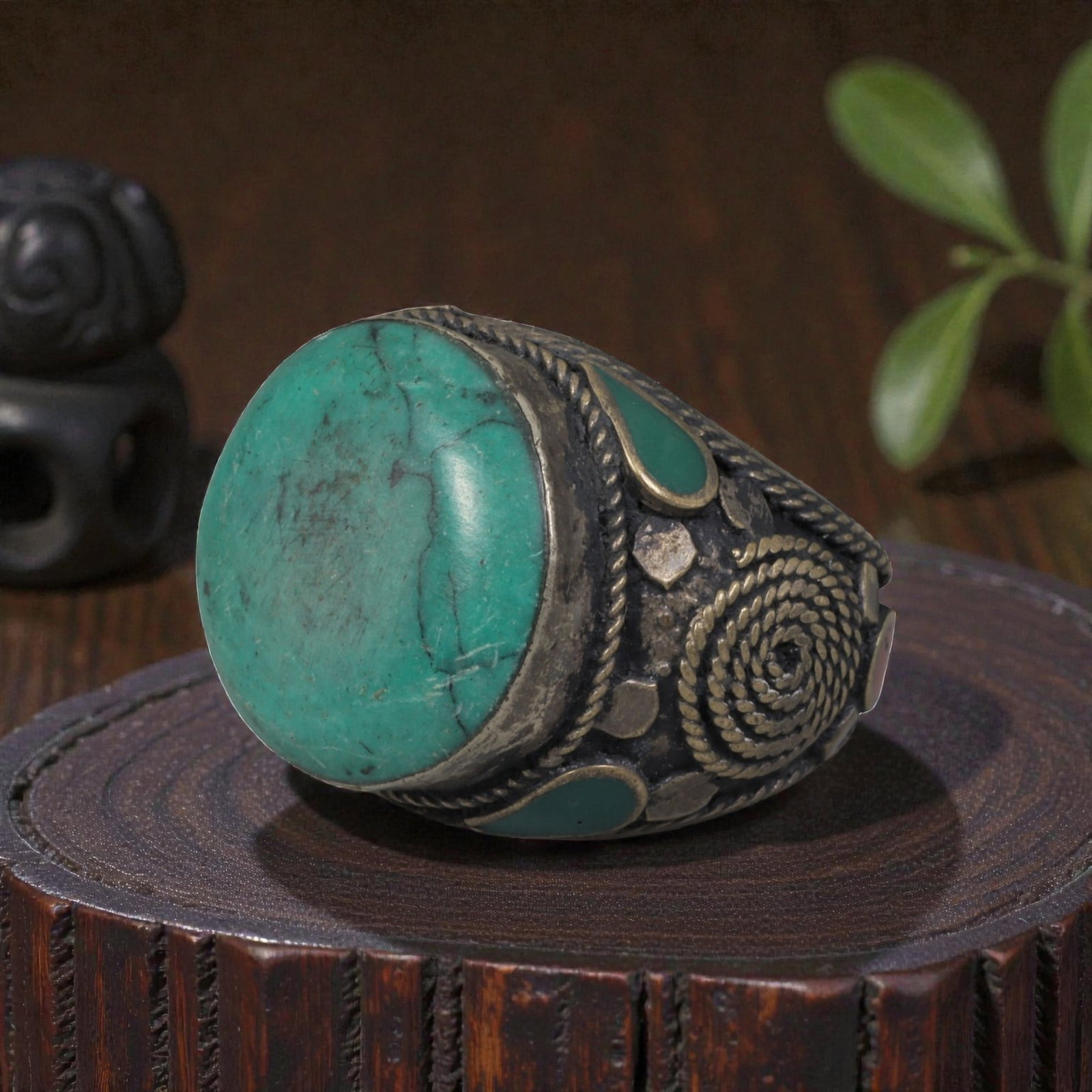 Antique Central Asian Silver and Turquoise Tribal Ring, 19th-Early 20th Century, 63AJ: The ring is set with a large, smooth cabochon turquoise stone, displaying natural matrix inclusions and surface cracks within its green-blue matrix. The silver mount is decorated with pseudo-filigree 
