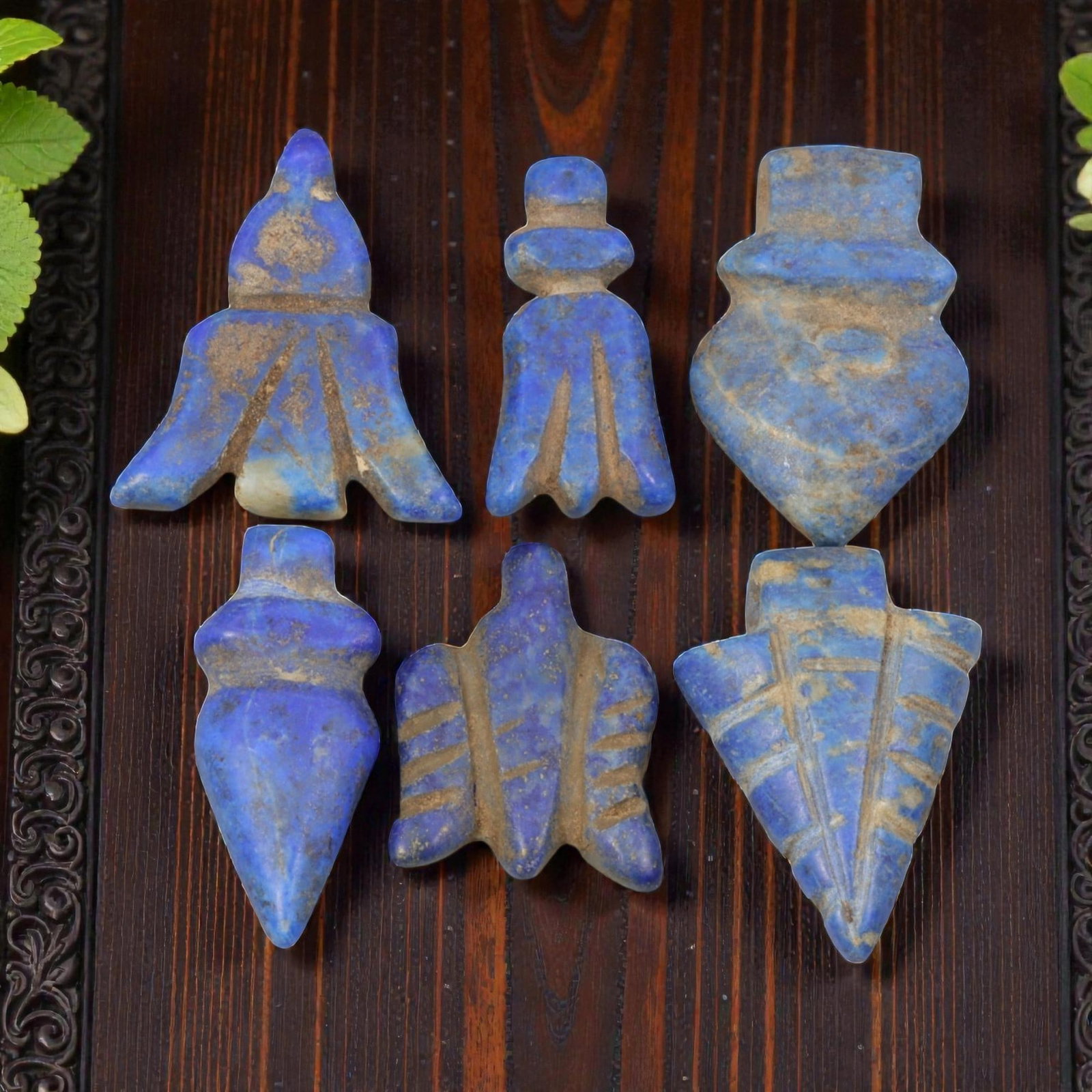 Lot of 6 Islamic Lapis Lazuli Amulet Beads, Circa Medieval Islamic Period, 60WM: A group of six hand-carved amulet beads crafted from lapis lazuli, showcasing the stone's characteristic deep blue hue with natural calcite and pyrite inclusions, alongside surface patination and eart