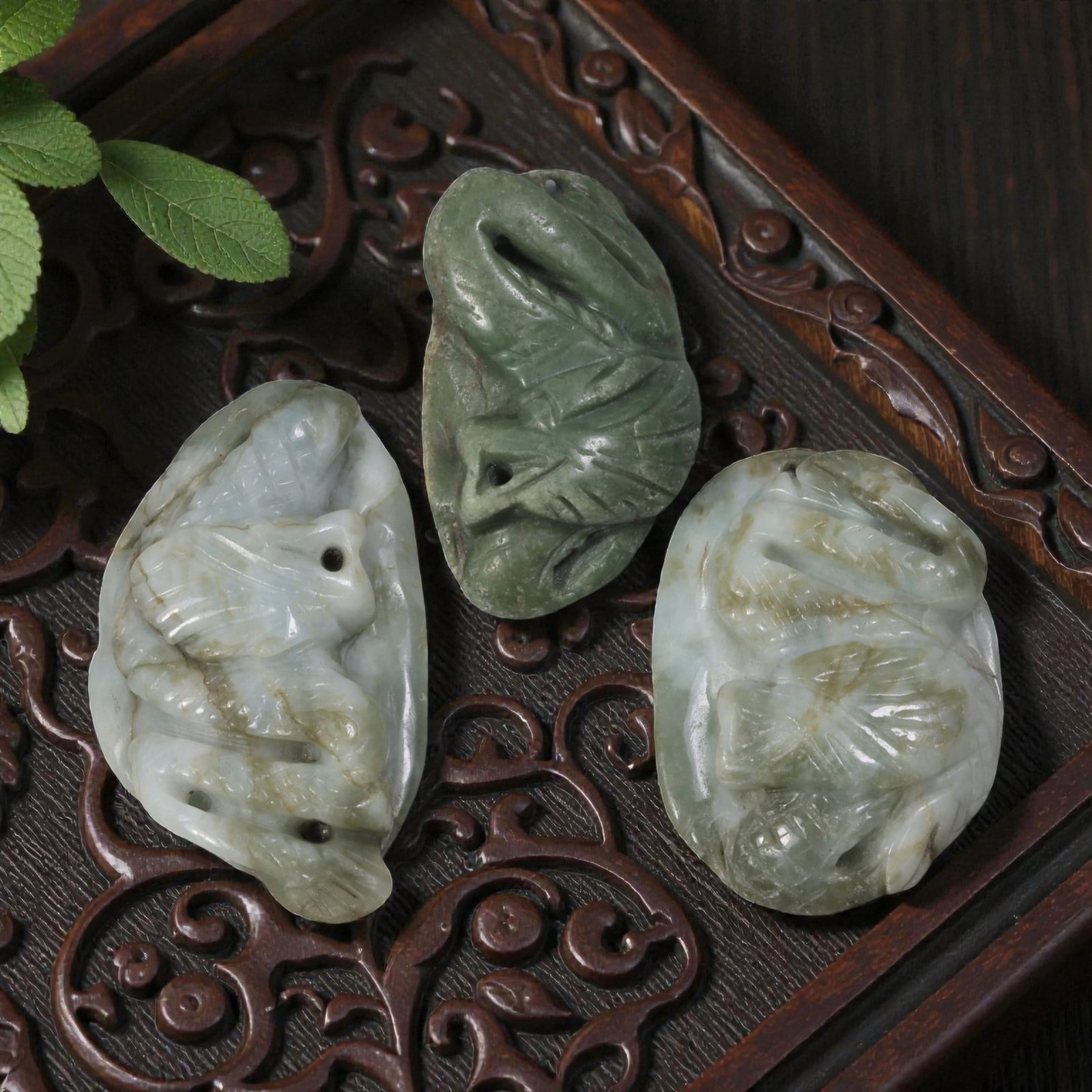 Lot of 3 Antique Oriental Chinese Jadeite Jade Carved Pendants, 46AG: The lot comprises three free-form jadeite pendants. The left pendant is carved from light greenish-white jadeite with natural brown inclusions, depicting a mythical dragon-like creature with defined s