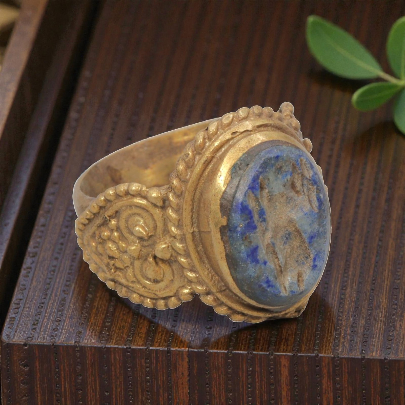 Antique Qajar Dynasty Gilt Intaglio Ring, US Size 9.5, 37WS: This ring features an oval lapis lazuli intaglio carved with a stylized motif, executed in the glyptic style characteristic of Qajar period Iran. The rich blue lapis displays natural mineral inclusion