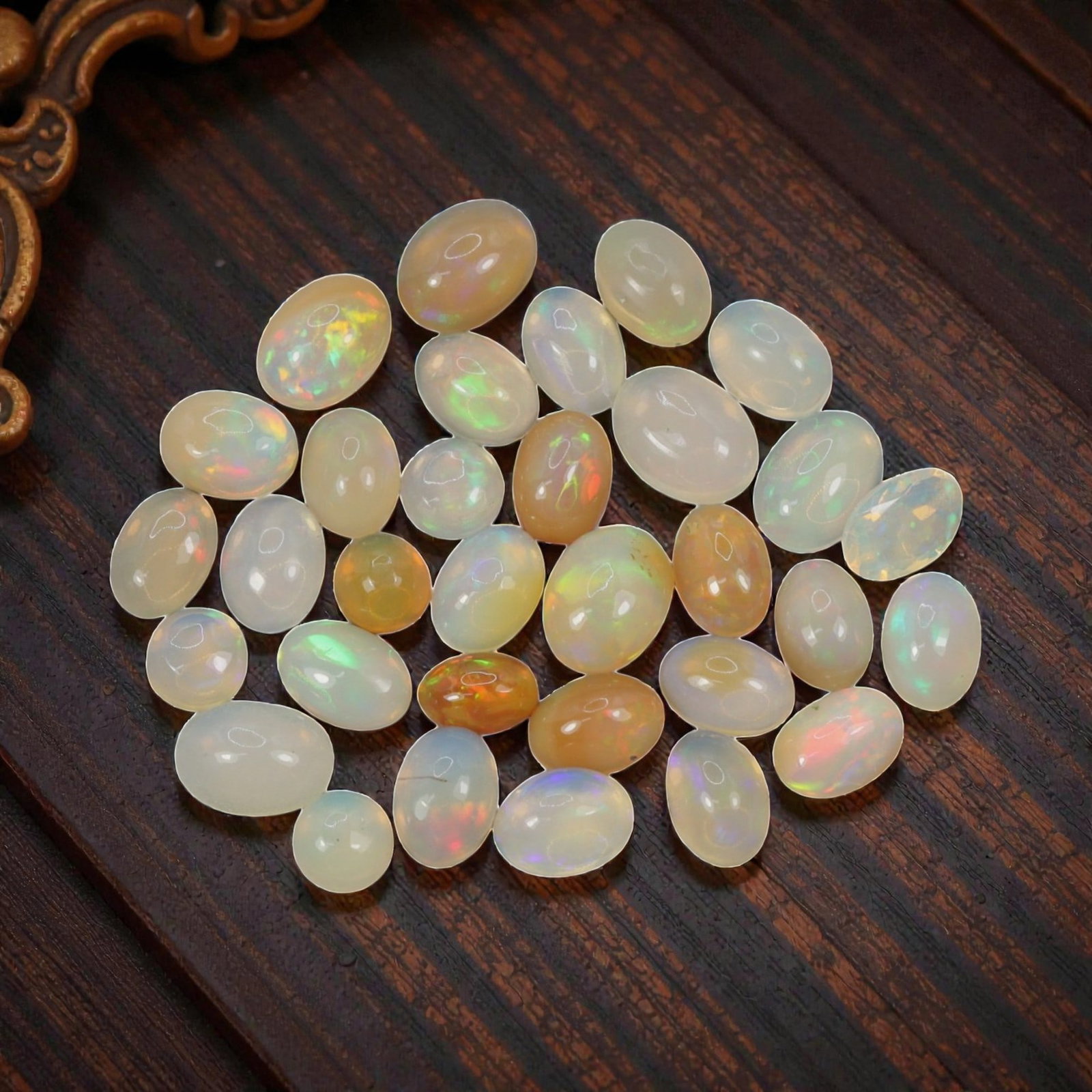 17.96 Carats Welo Opal Cabochon Parcel - Natural Ethiopian Stones, 56XA: This luminous collection of Welo opals showcases a rich spectrum of translucent body tones, from milky white and soft cream to warm honey and golden amber, each adorned with vivid, shifting color play