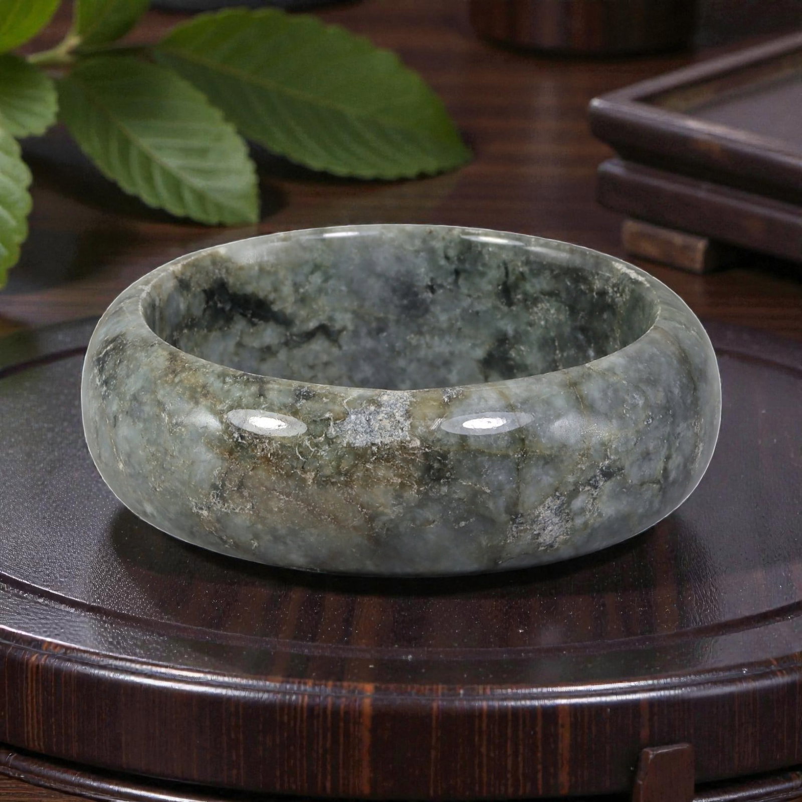 Natural Burmese Type A Grey & Black Jadeite Bangle - Earthy Pattern Bracelet, 20EA: This is a wide, substantial bangle crafted from natural Burmese Type A jadeite, displaying a muted grey-green base with deep black and earthy brown patterning, evoking the texture of weathered stone. 