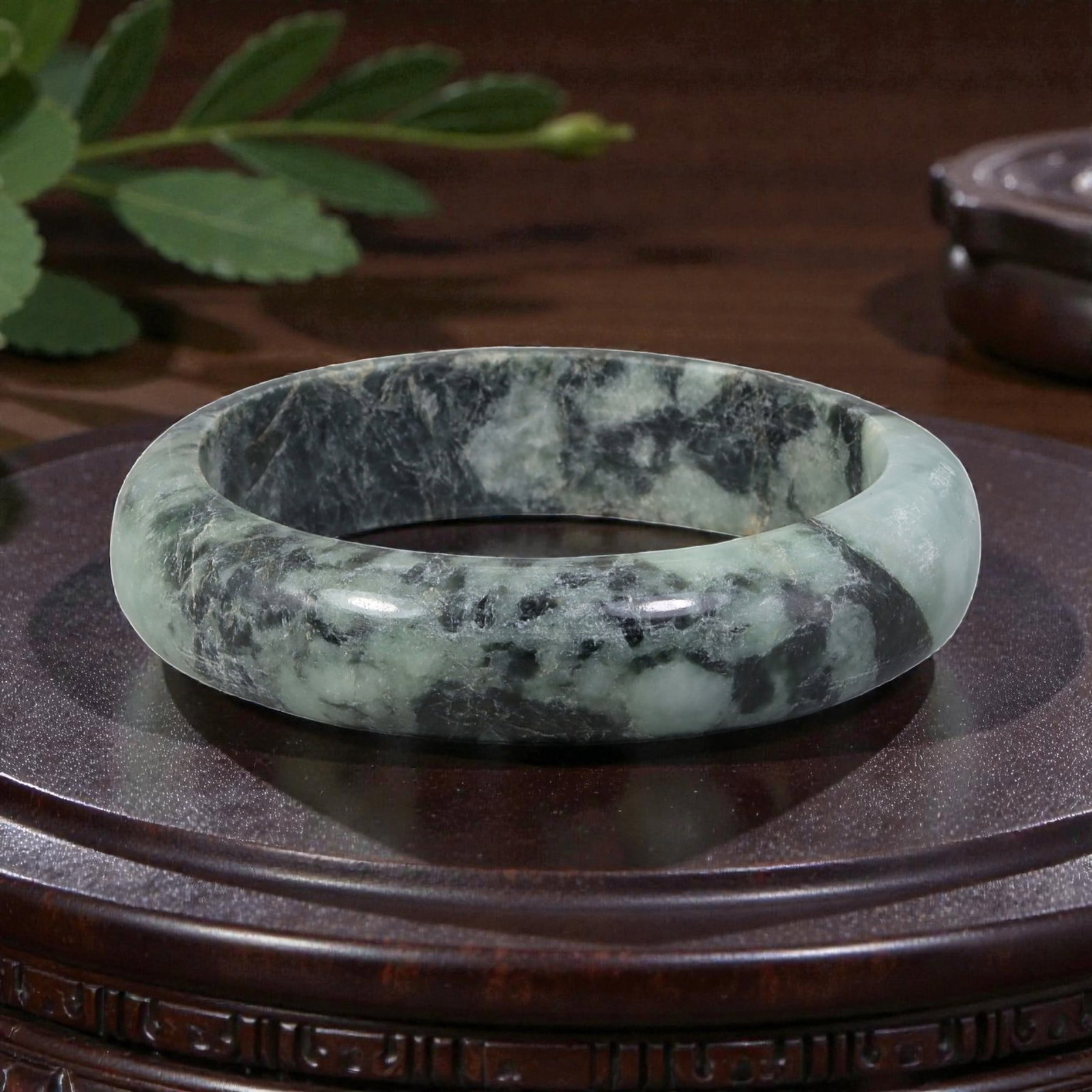 Natural Burmese Type A Light Green Jadeite Bangle - Bold Ink Wash Bracelet, 23EA: This is a wide, solid bangle crafted from natural Burmese Type A jadeite, displaying a soft light green base with dramatic black ink-wash patterning that evokes natural stone art. The surface exhibits