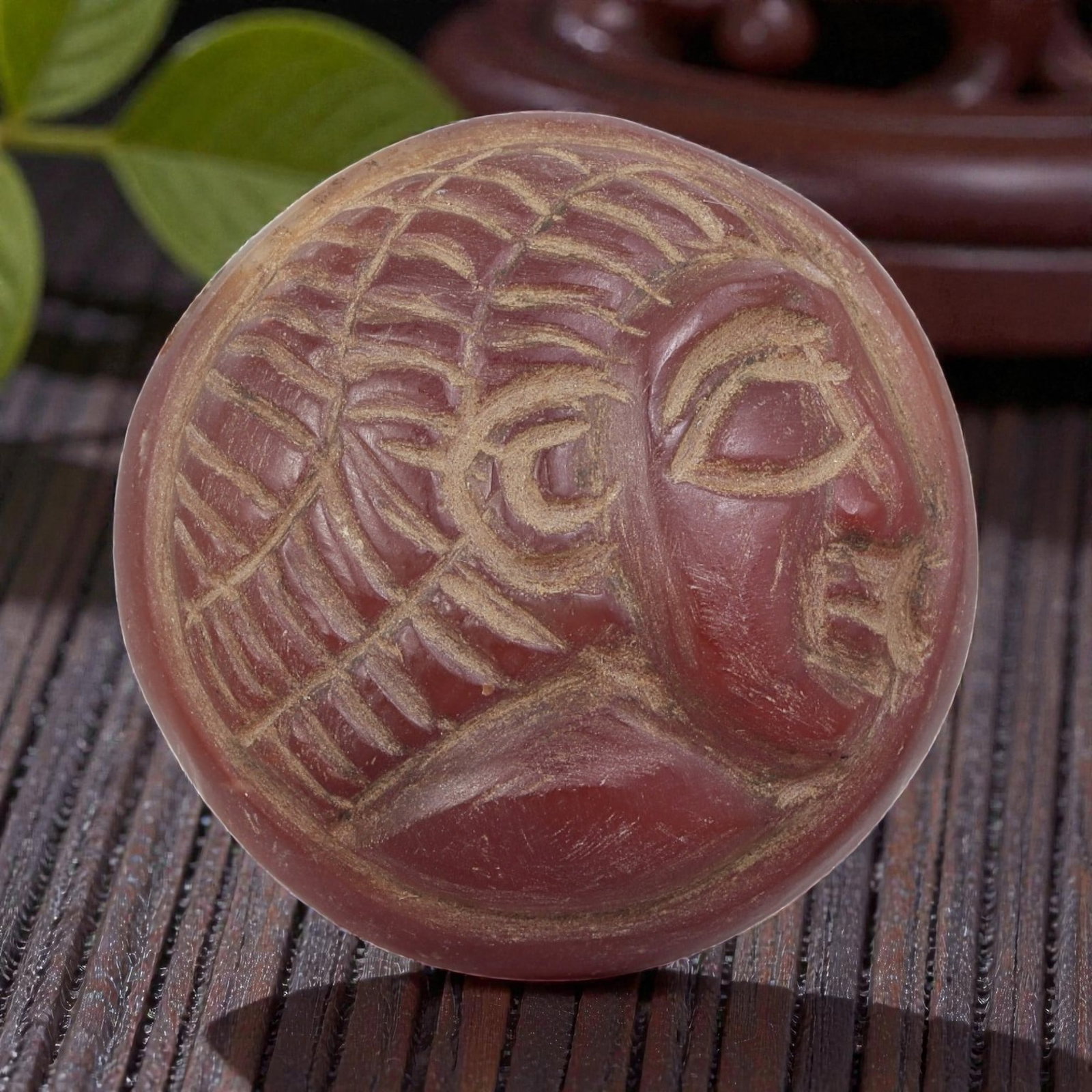 Antique Egyptian Carnelian Intaglio with Profile Head Motif, 97AN: Carved from carnelian with rich reddish-orange coloration, the oval-shaped intaglio features an incised profile head of a figure wearing a detailed headdress. The carving includes defined facial featu
