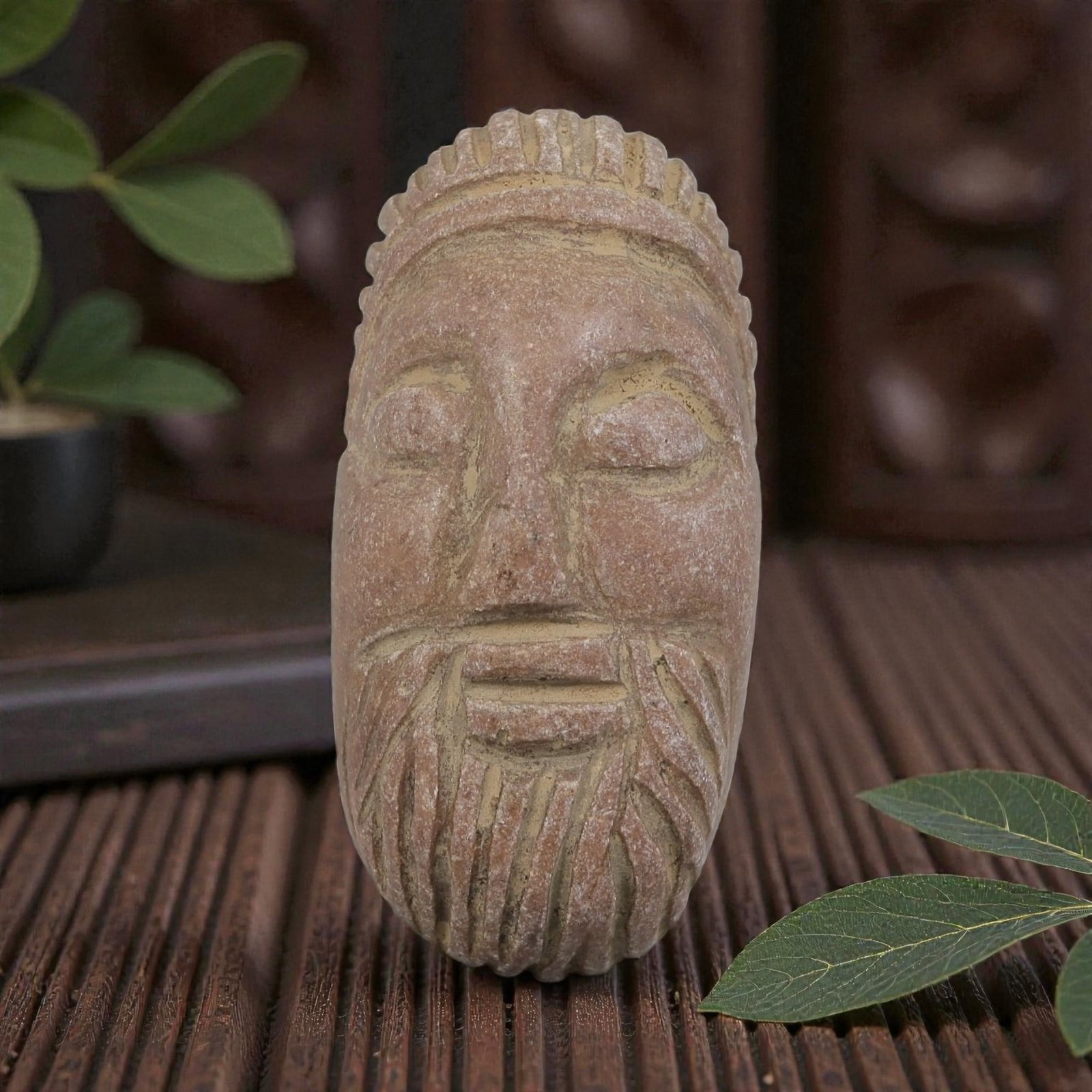 Antique Islamic Carved Stone Bearded Bust Intaglio, 86AN: Carved from soft, weathered pinkish stone, this elongated intaglio depicts a stylized bearded male face in relief. The figure features closed eyes, a straight nose, and a neatly carved beard with vert