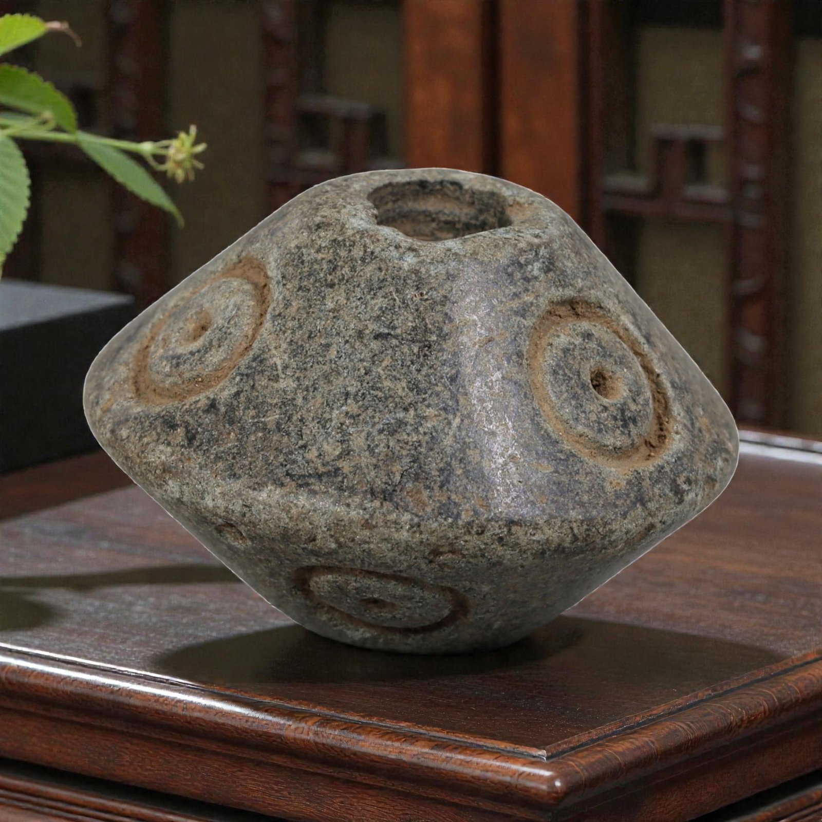 Antique Silk Road Schist Biconical Bead with Concentric Circle Motifs, 14AP: Crafted from weathered dark grey schist, this antique biconical bead features a symmetrical, spindle-shaped form characteristic of Silk Road trade artifacts. Its surface is adorned with deeply incised