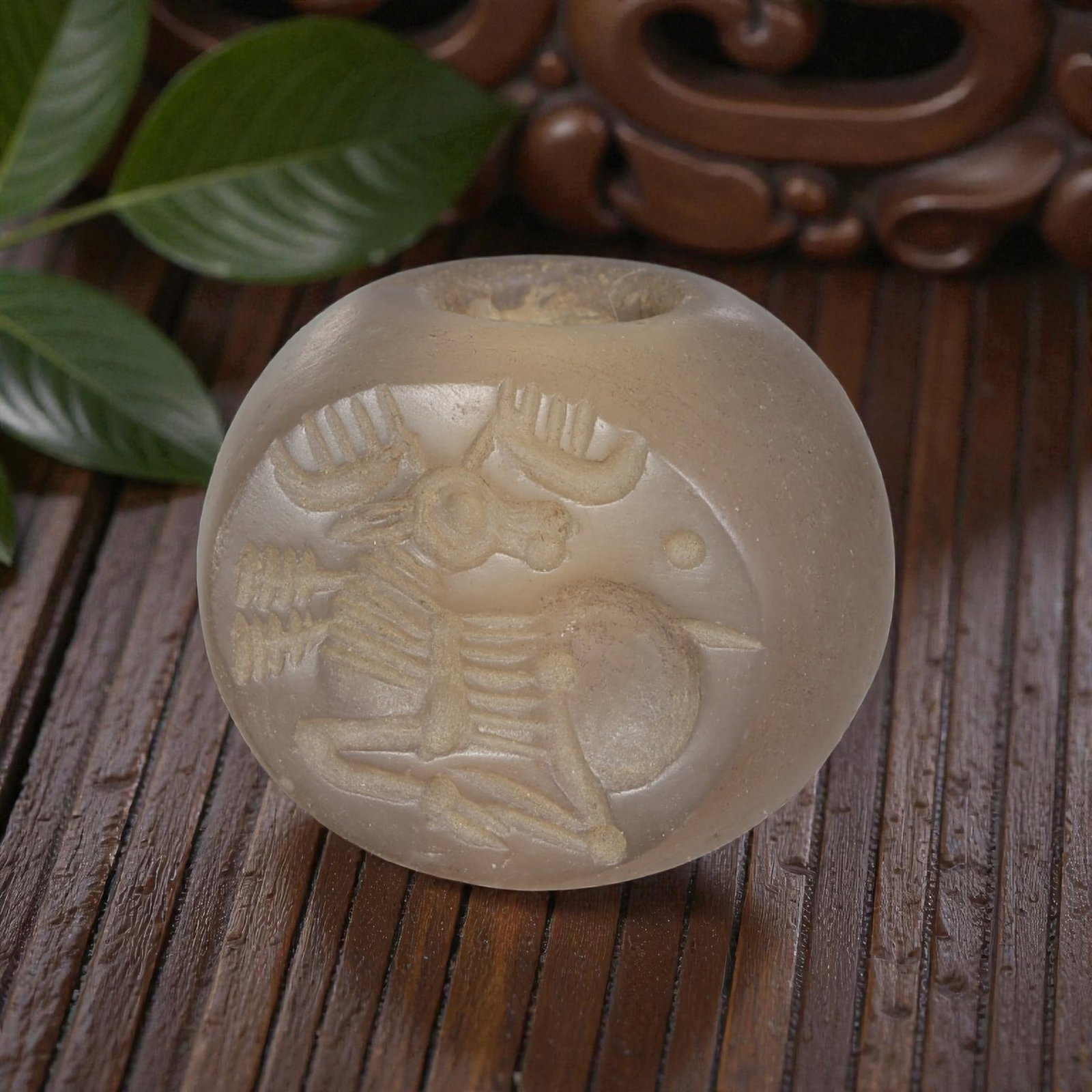Ancient Sasanian Chalcedony Zoomorphic Stag Stamp Seal, 28AP: Crafted from pale, translucent chalcedony, this ancient Sasanian stamp seal features a deeply incised motif of a stylized stag in profile, a common zoomorphic theme in Sasanian iconography symbolizing